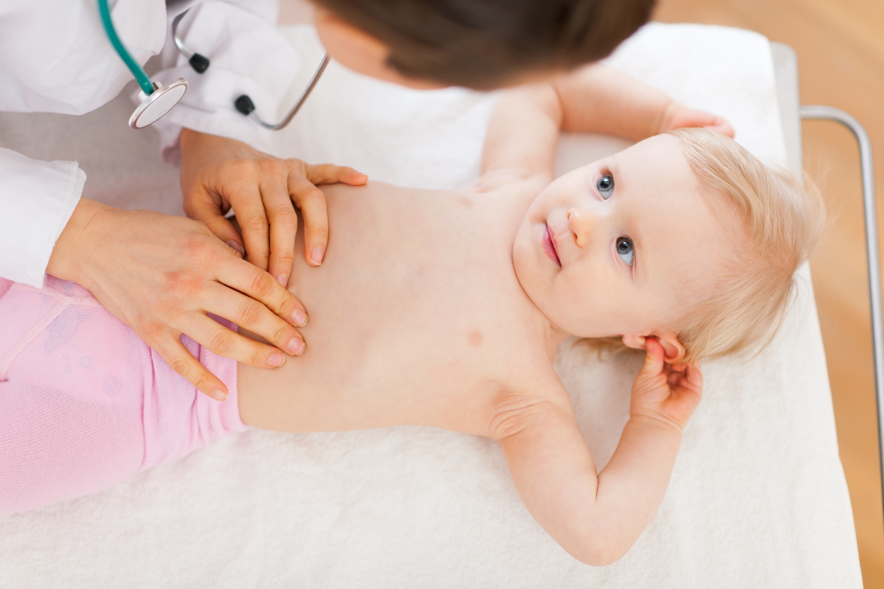 A child's abdomen being massaged