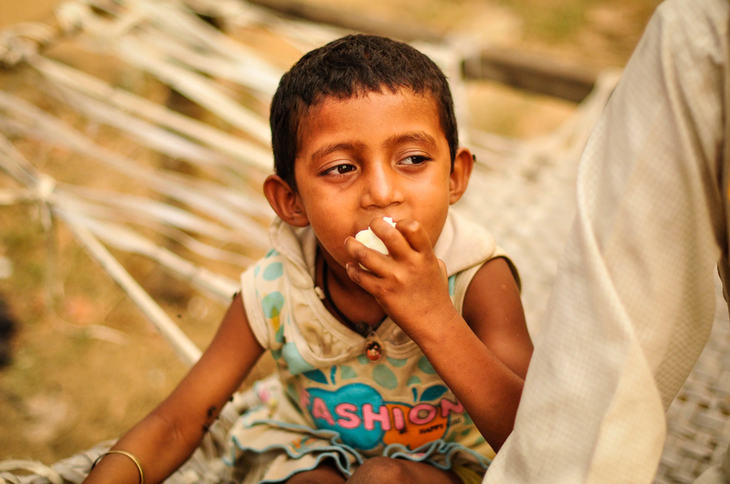 Children are not considered very precious in India---especially girl ones. This little one is paralyzed and does not receive enough nutritious food with protein She's eating an egg we gave her here.