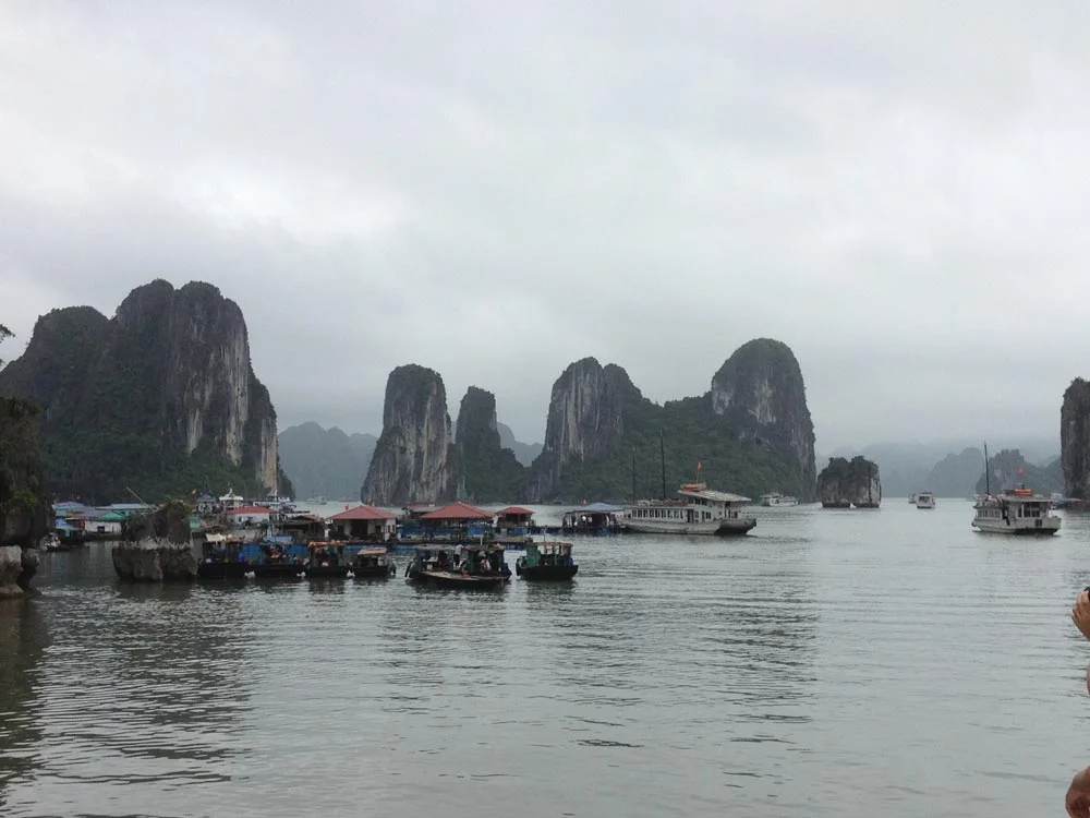 Fishing villages at halong bay, vietnam. Those are houses floating on the water. It is an entire village including schools for the kids and everything. 