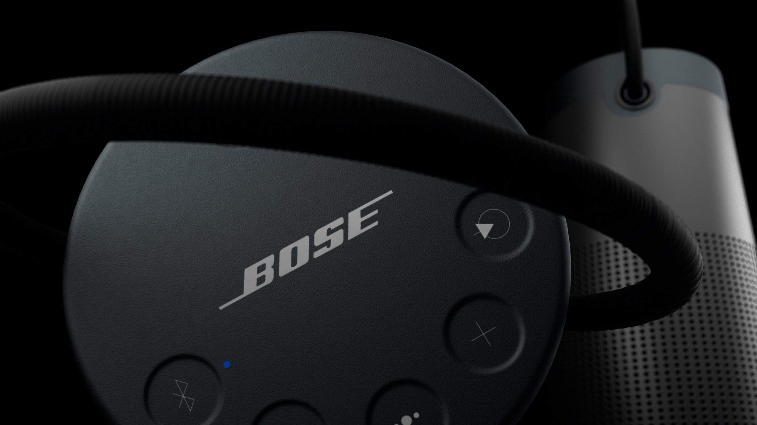 Photorealistic 3D render of Bose Bluetooth speaker showcasing textured buttons and power cable, highlighting product detail and lighting.