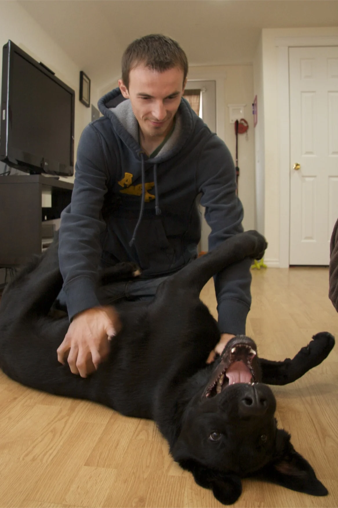  Vadeem Lemeza plays with his dog “Mishka” at his home in Missoula. Lemeza moved to Missoula from Belarus with his family in 1996 due to fears of religious prosecution following the collapse of the Soviet Union. Despite claiming himself as “Americani