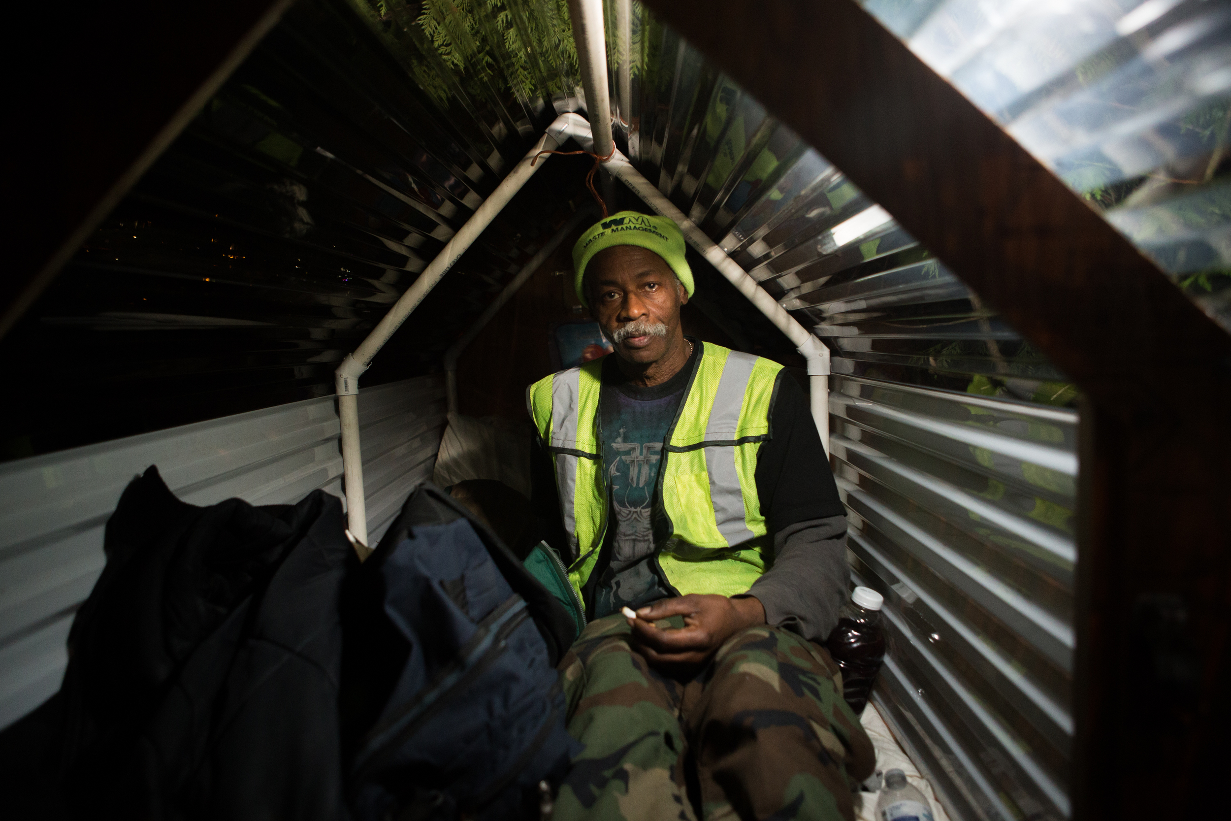 James Hubbard inside his mobile shelter. Since November, volunteers in Tacoma have been building mobile shelters and giving them away to homeless people.