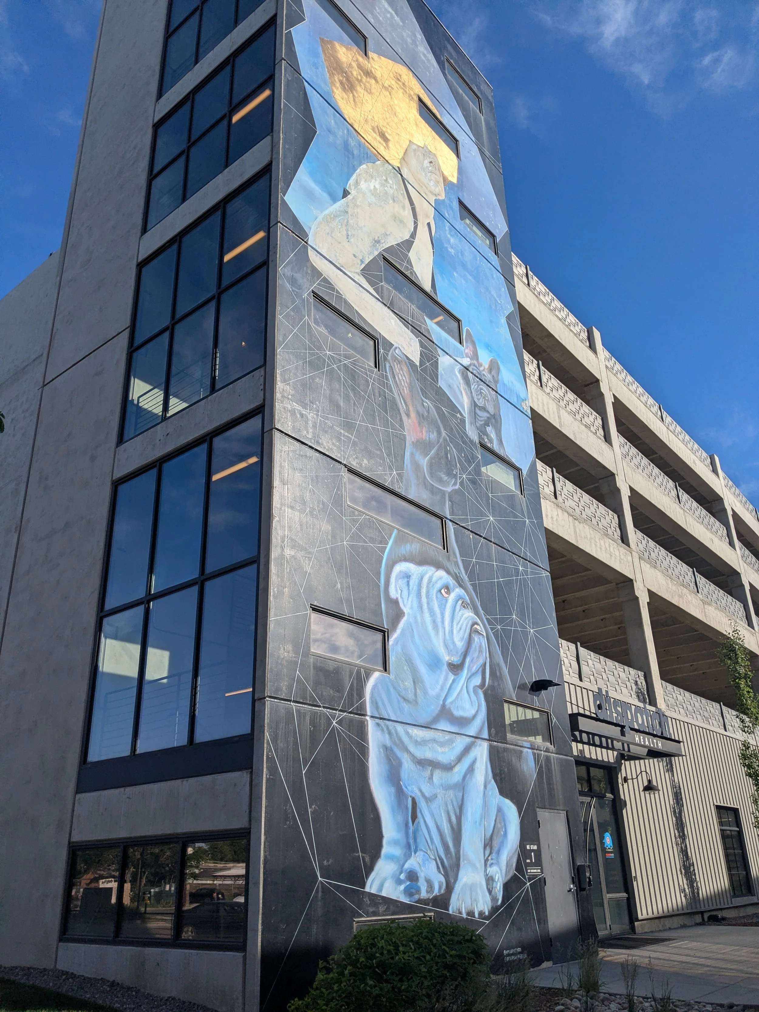 Art on one of many parking garages in the RiNo Arts District with dogs and a person