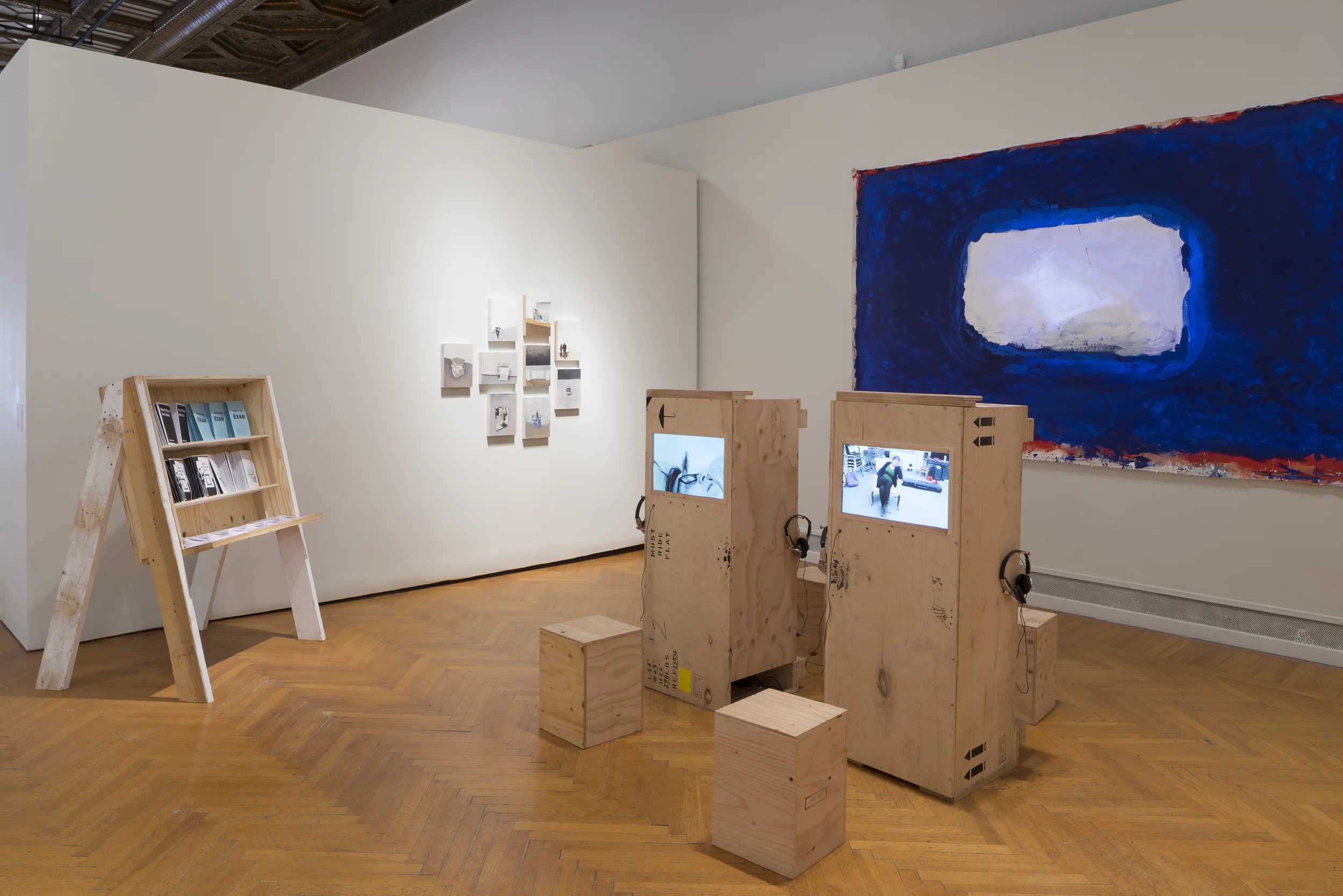 11 oil paintings, 1 projection on acrylic on canvas, 1 zine rack with zines, 1 single channel looped video on 4 screens in wooden crates 