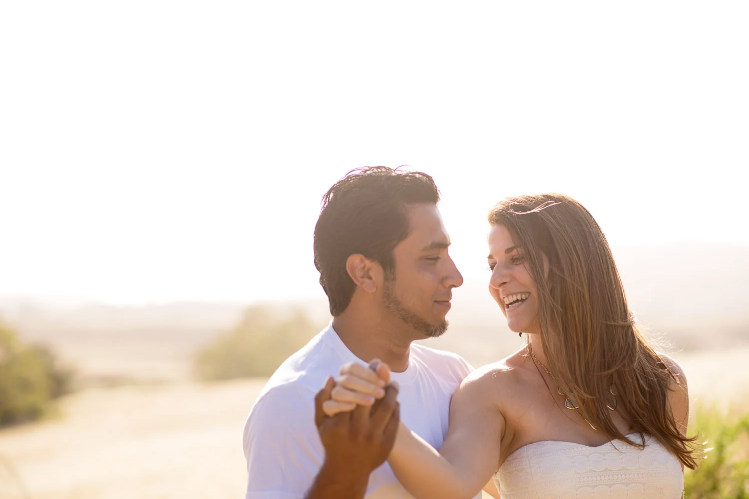 f27-photography-ventura-county-thousand-oaks-engagement-golden-field-holding-hands-laughing.jpg