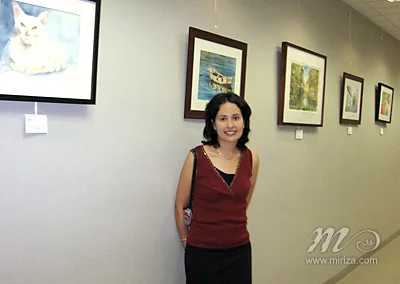 Michelle with some of her paintings at the School District of Palm Beach County.