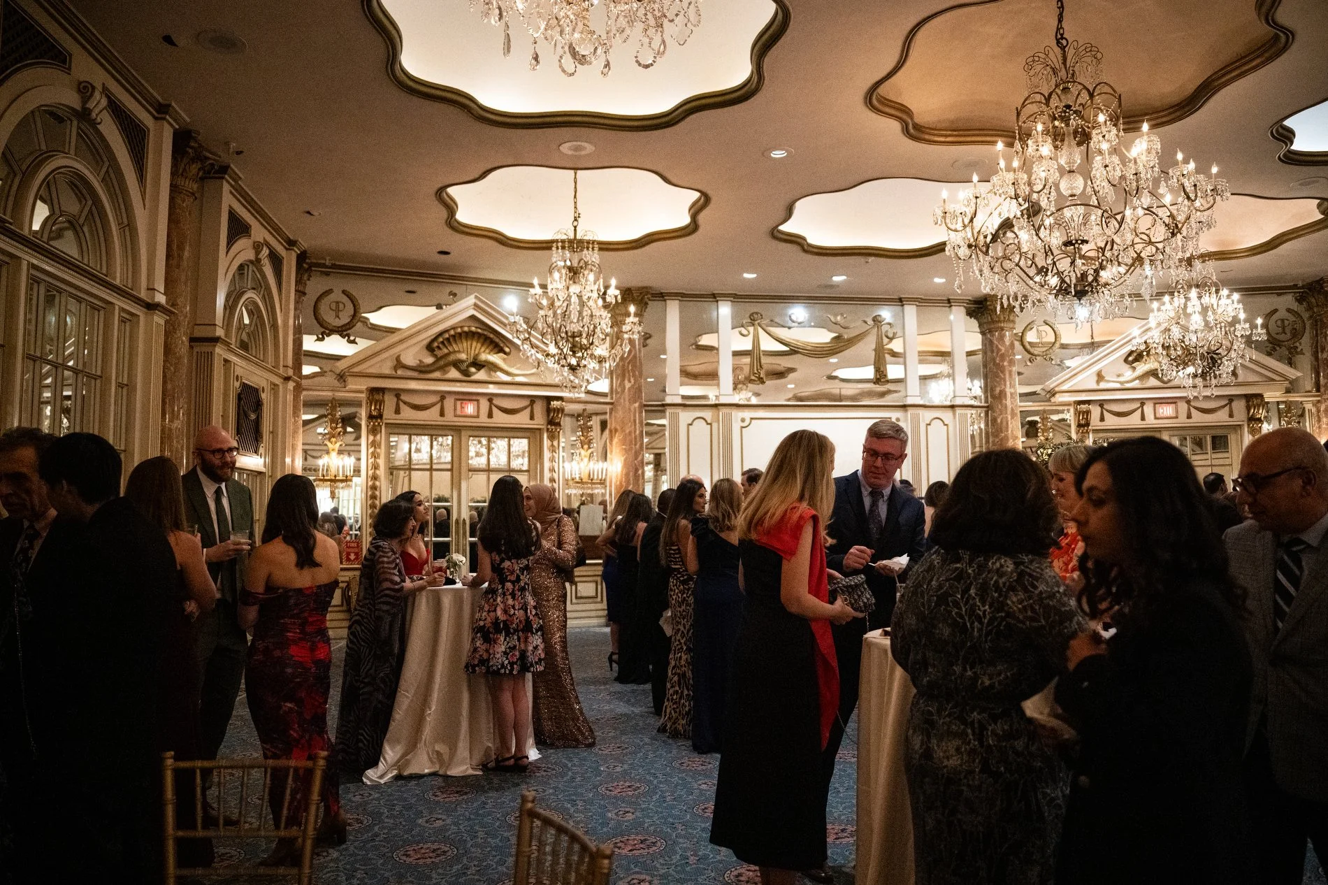 Guests enjoy cocktail hour at a documentary style wedding photography session at Fairmont Copley Plaza in Boston.