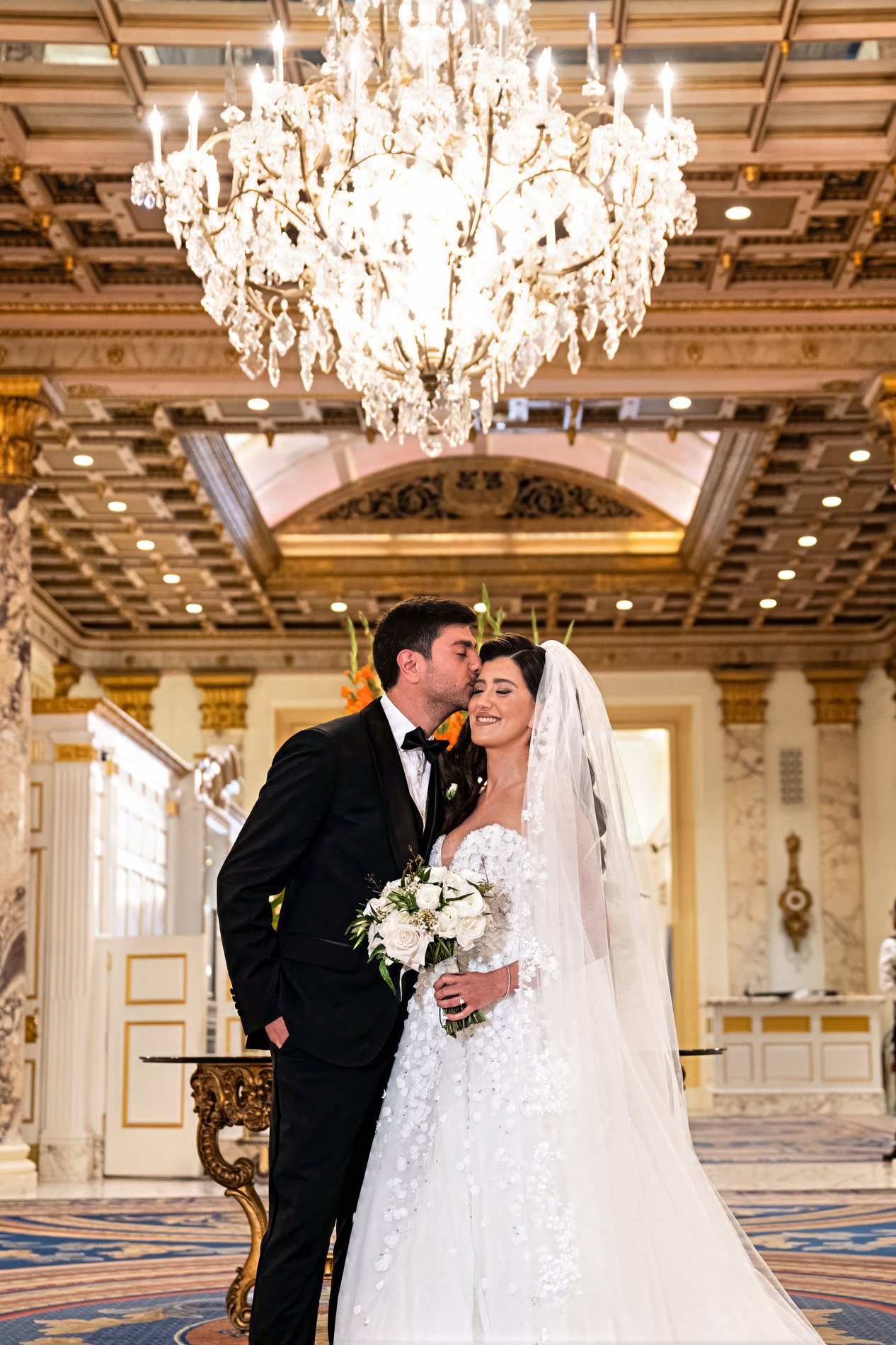 A couple poses for a portrait during their Boston hotel wedding.
