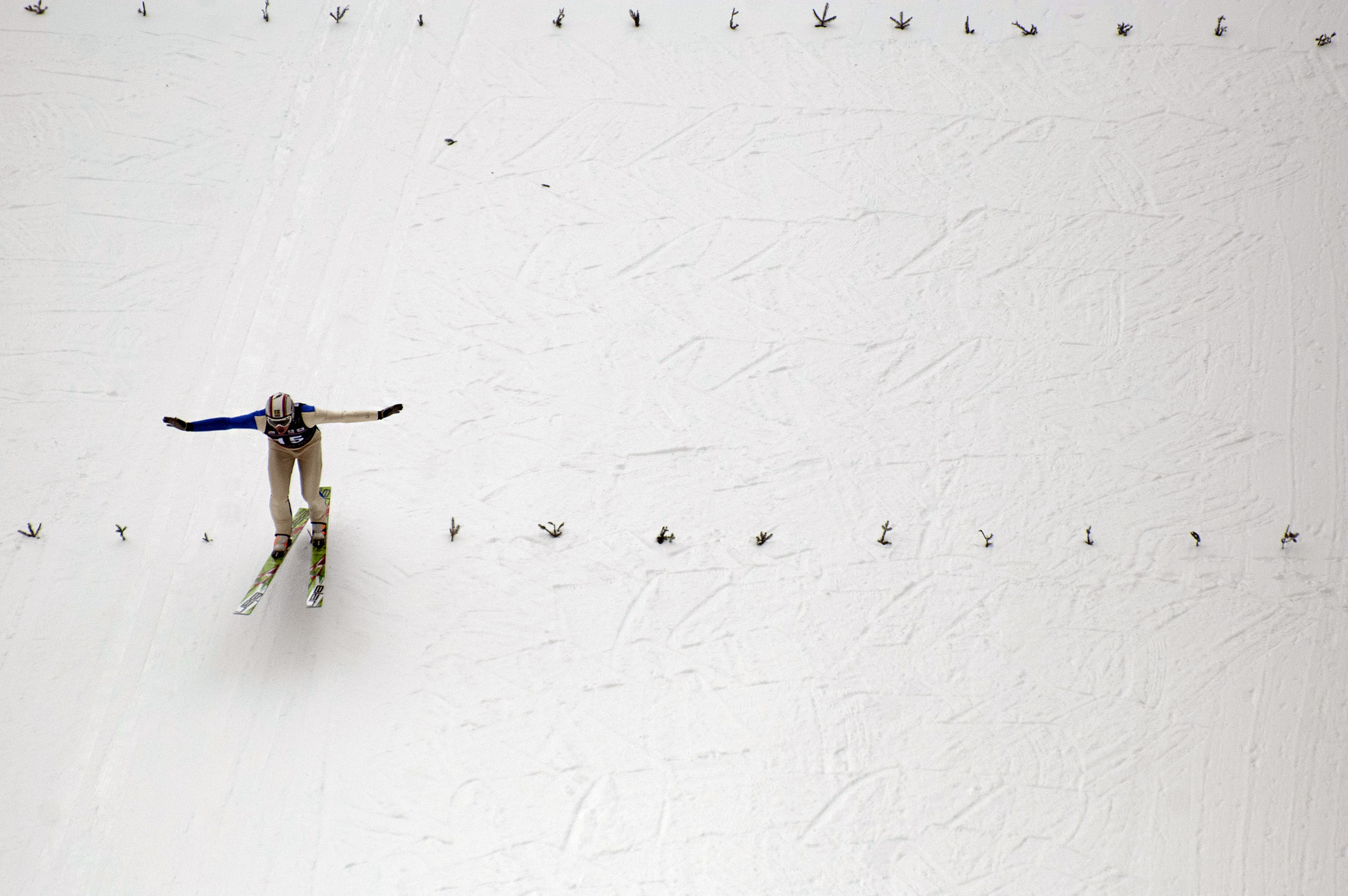 Ski jumper Erik Gundersson of Sweden prepares to land during a jump at the Harris Hill ski jumping competition on Feb. 15, 2014.
