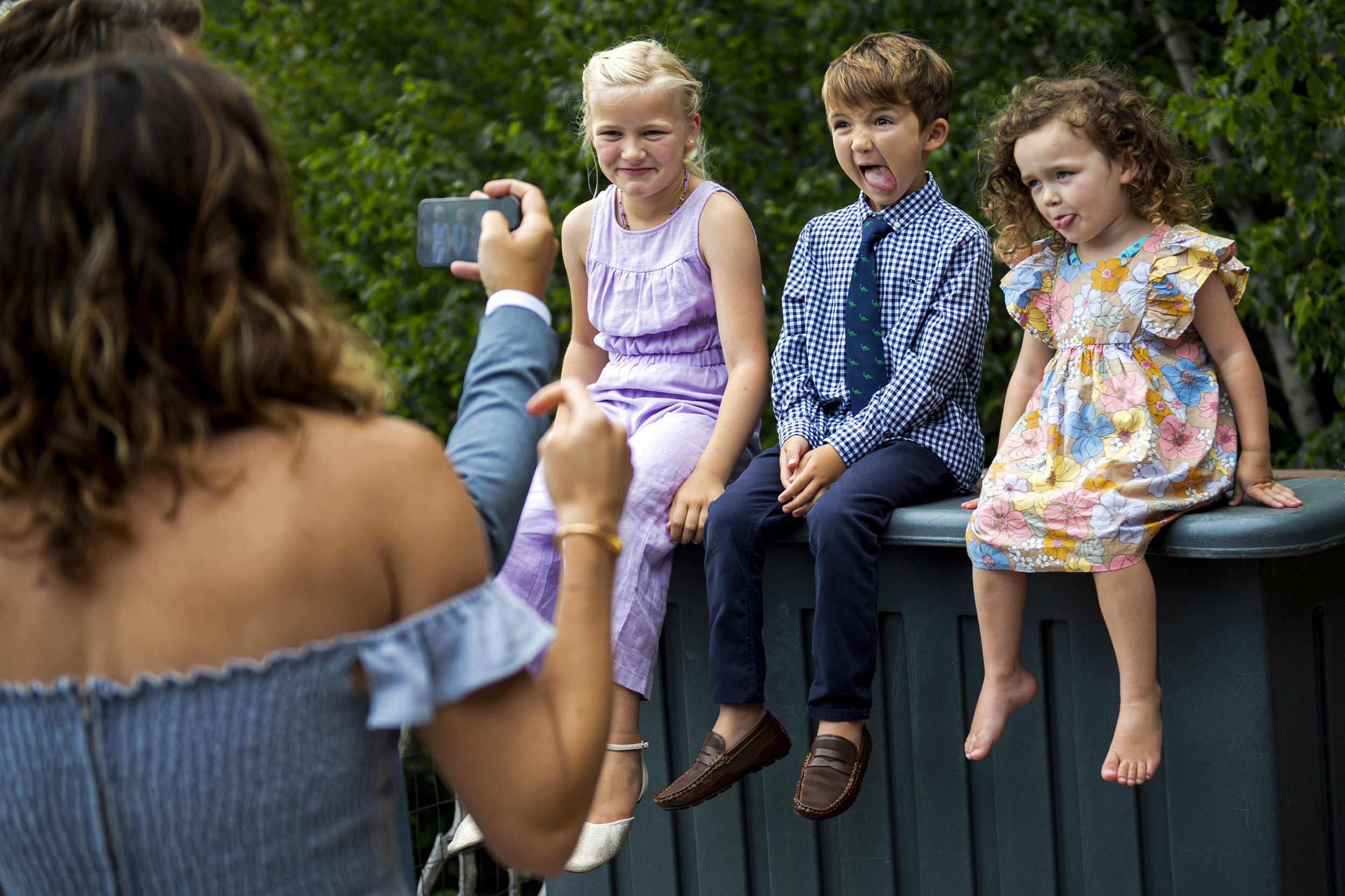  Kids make faces while posing for a photo at the Ponds at Bolton Valley during a Vermont wedding photography session.  