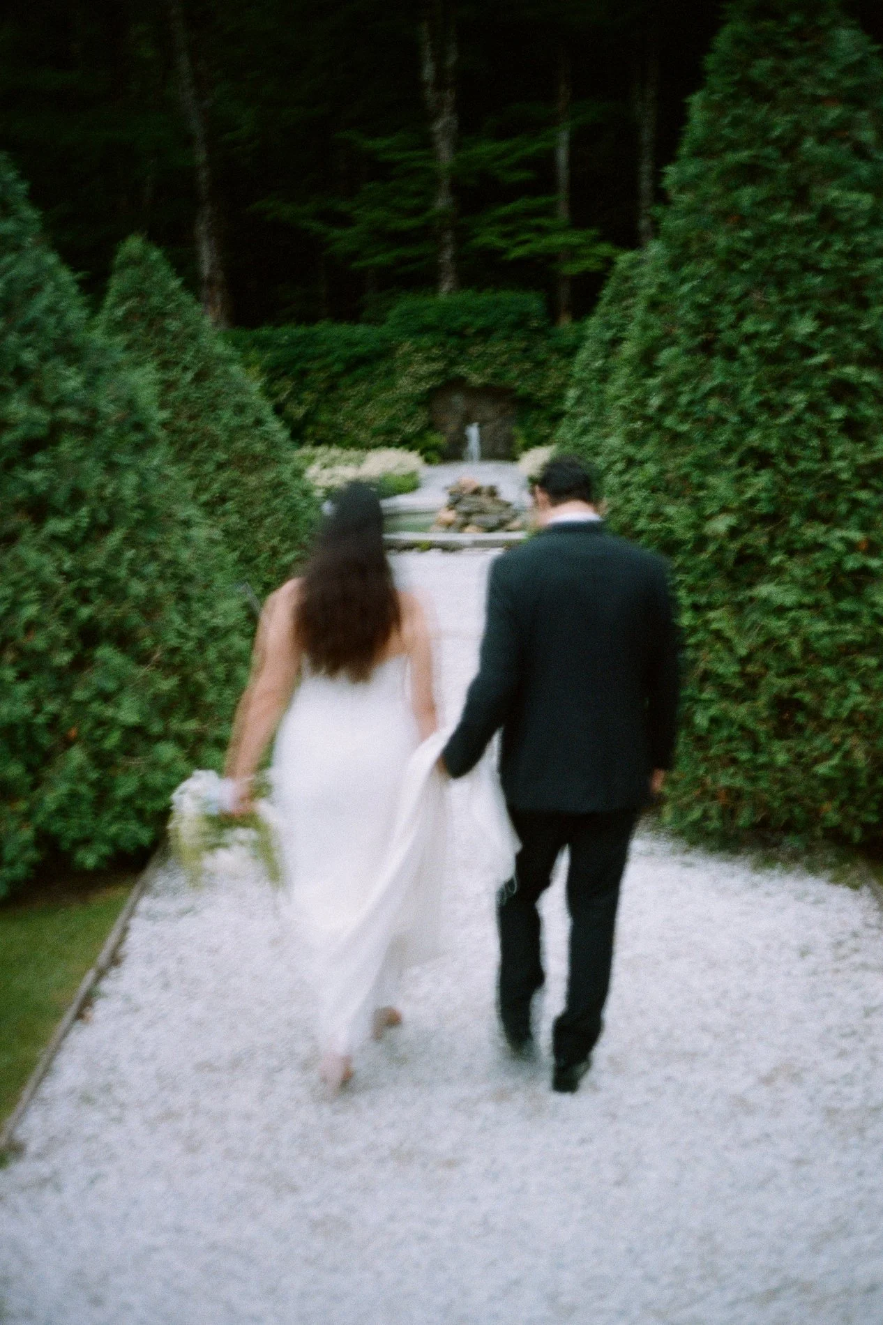 A couple walks together into the Italian Garden at The Mount during their romantic wedding in the Berkshires.