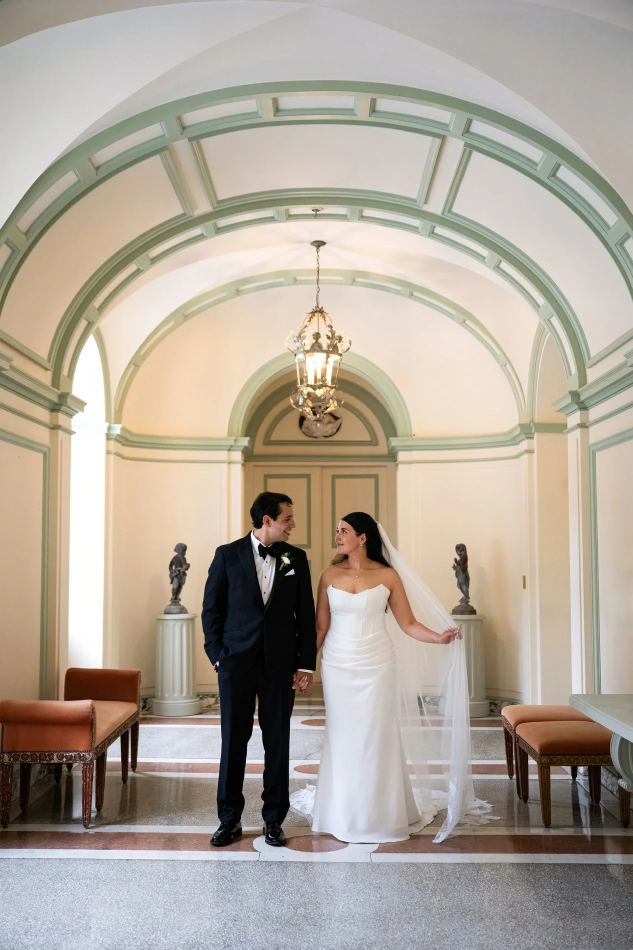 A couple poses inside the historical home of Edith Wharton during their wedding at The Mount in the Berkshires