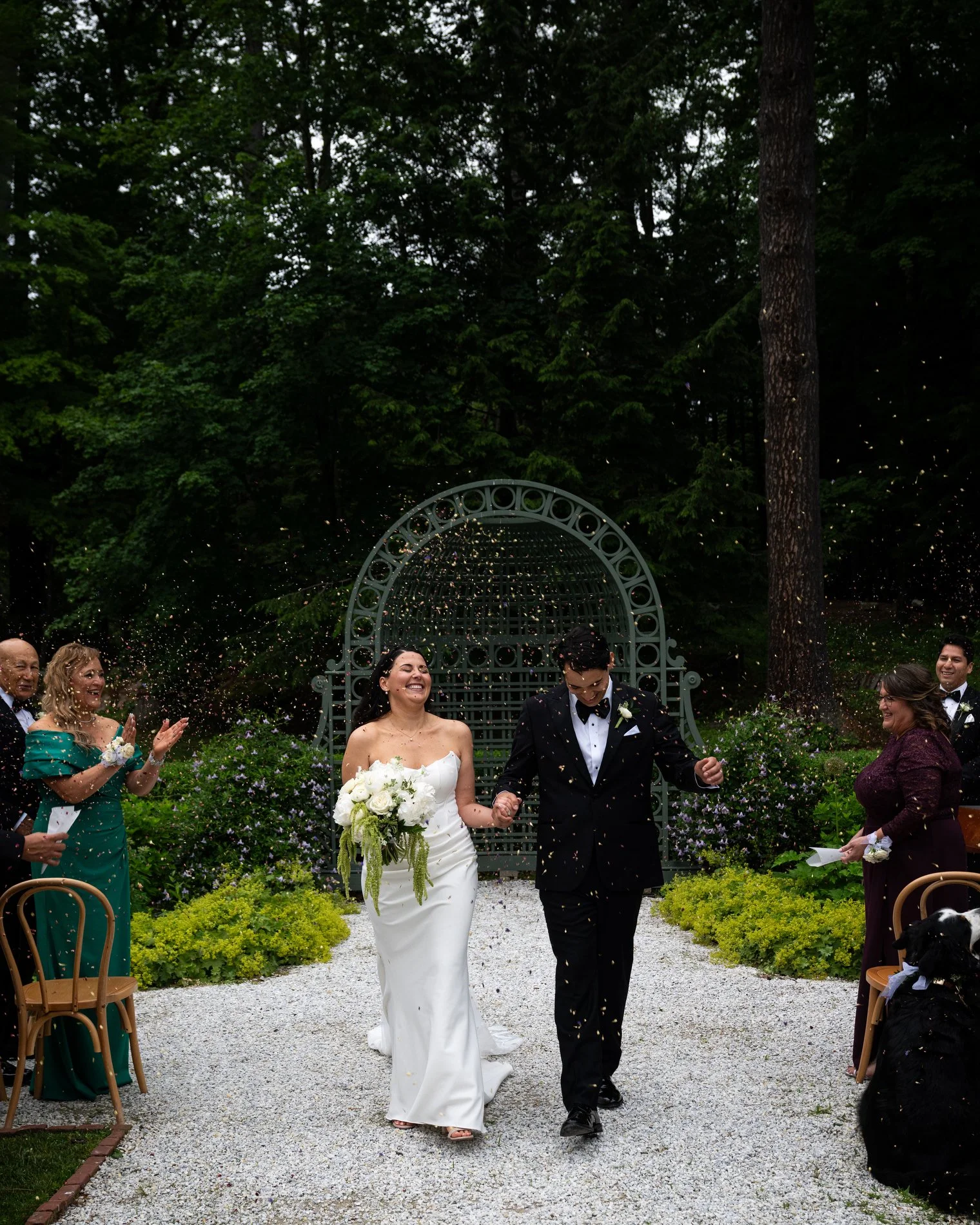 A couple celebrates as they walk down the aisle together after their wedding ceremony at The Mount in Lenox, Massachusetts.