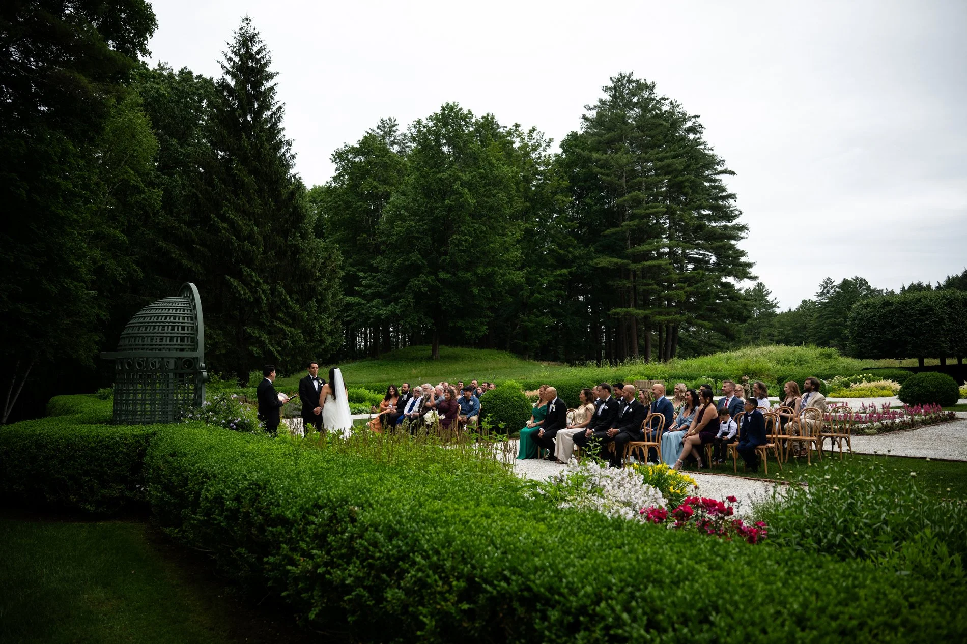 A ceremony takes place in the Versailles-inspired French Garden at The Mount in the Berkshires.