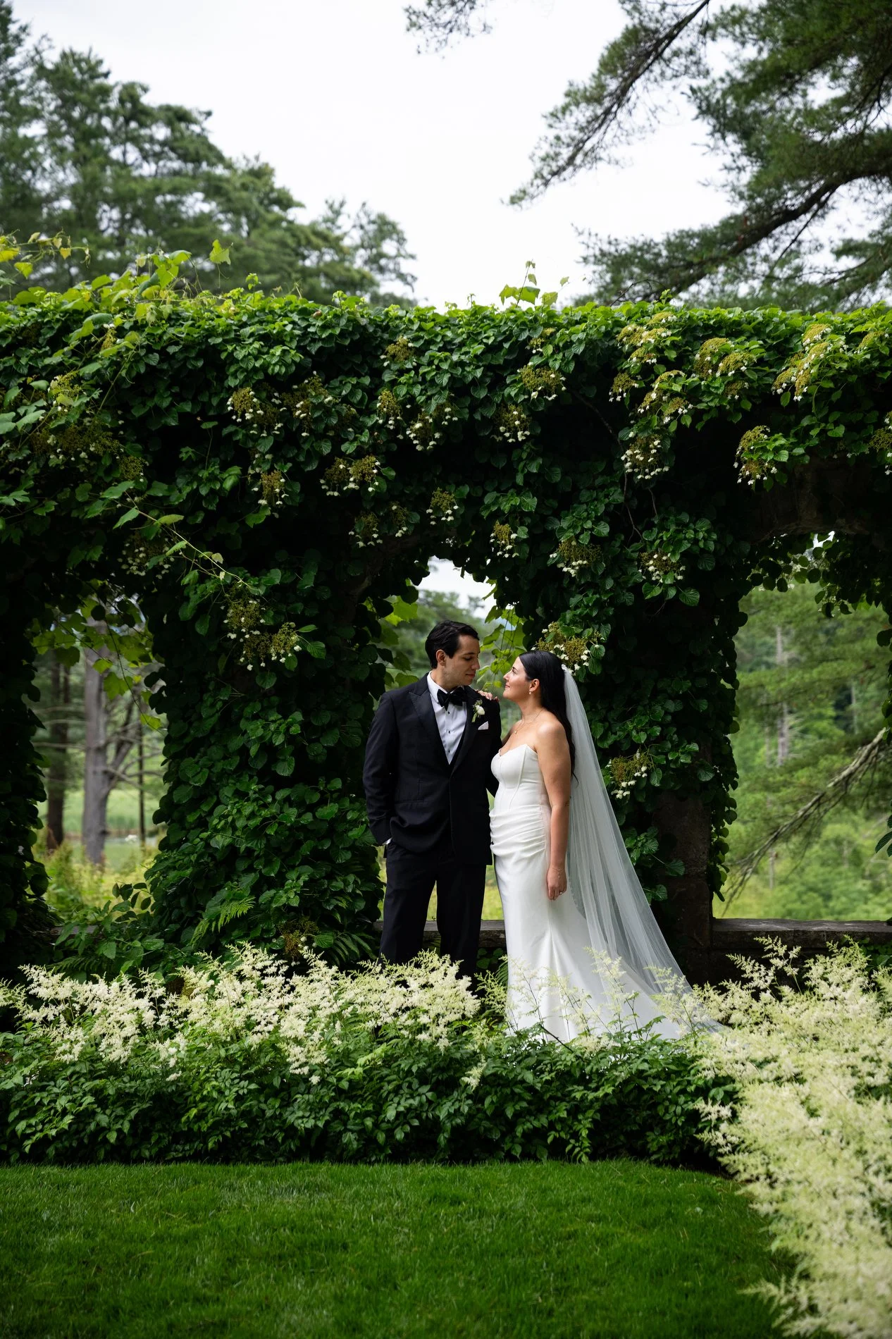 A bride and groom walk together through the Italian garden at The Mount during their romantic Berkshires wedding.
