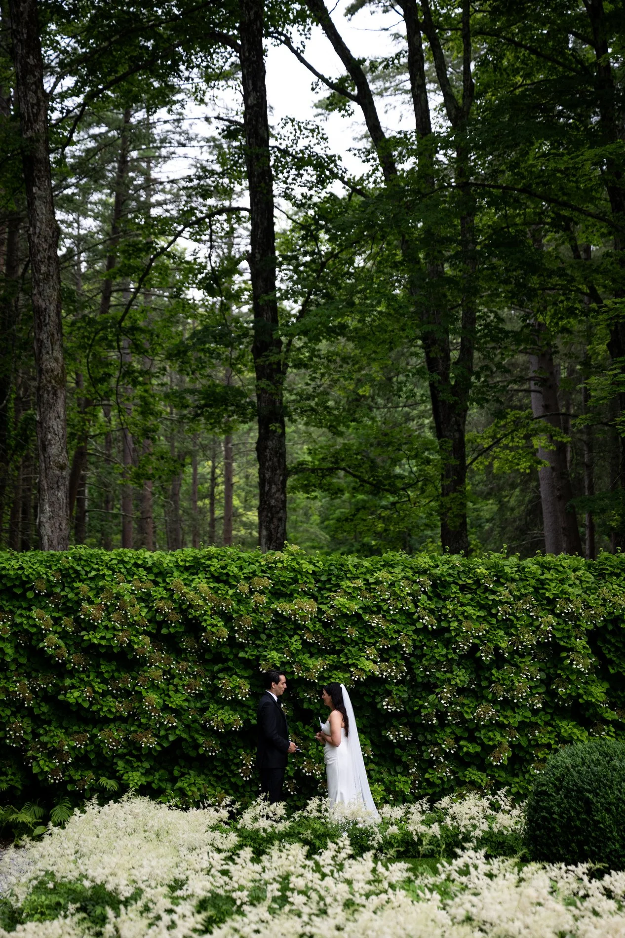 A bride and groom share vows in the Italian garden at The Mount during their romantic Berkshires wedding.