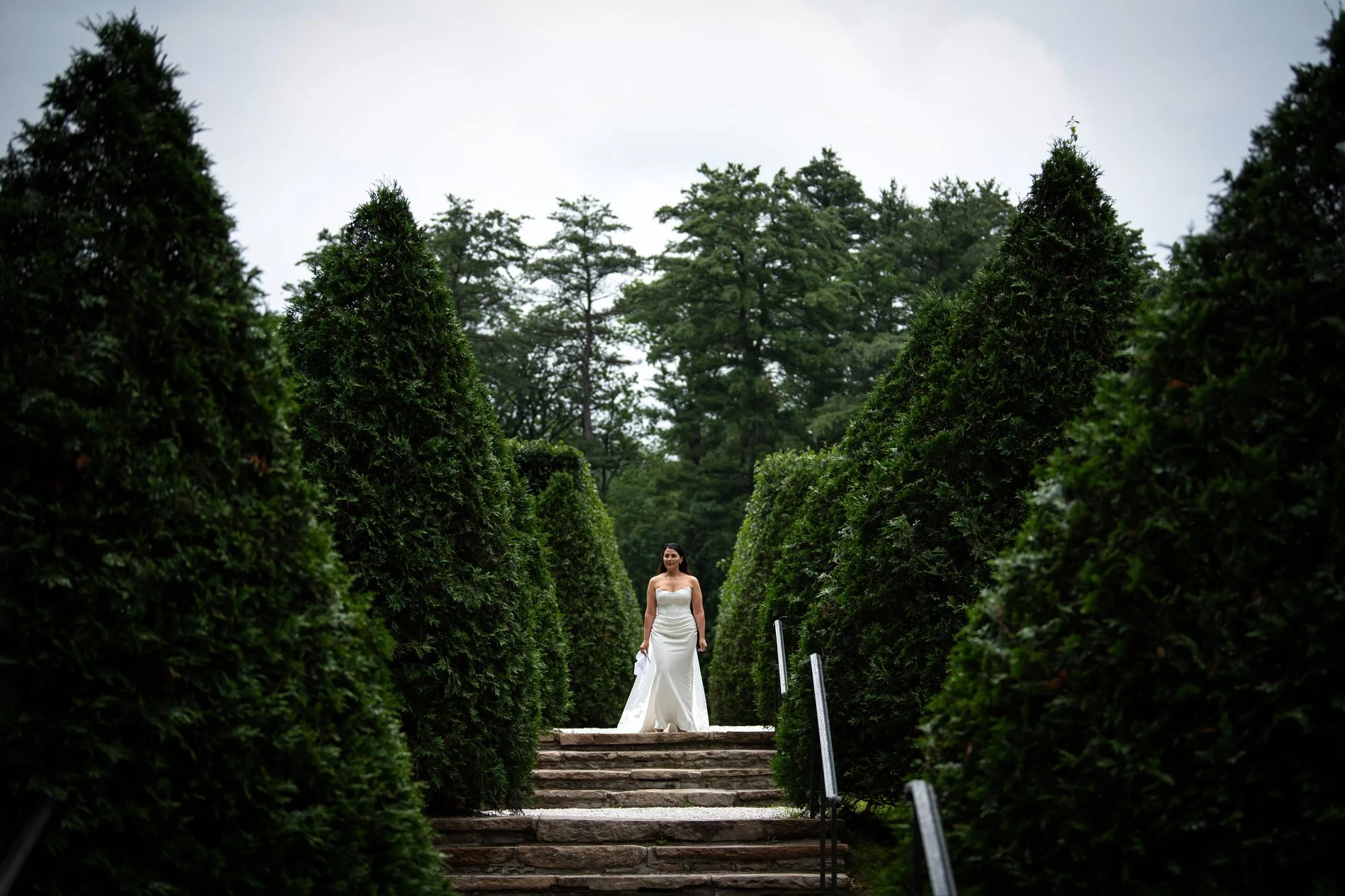 A bride walks down steps to the Italian garden at The Mount during her romantic Berkshires wedding.