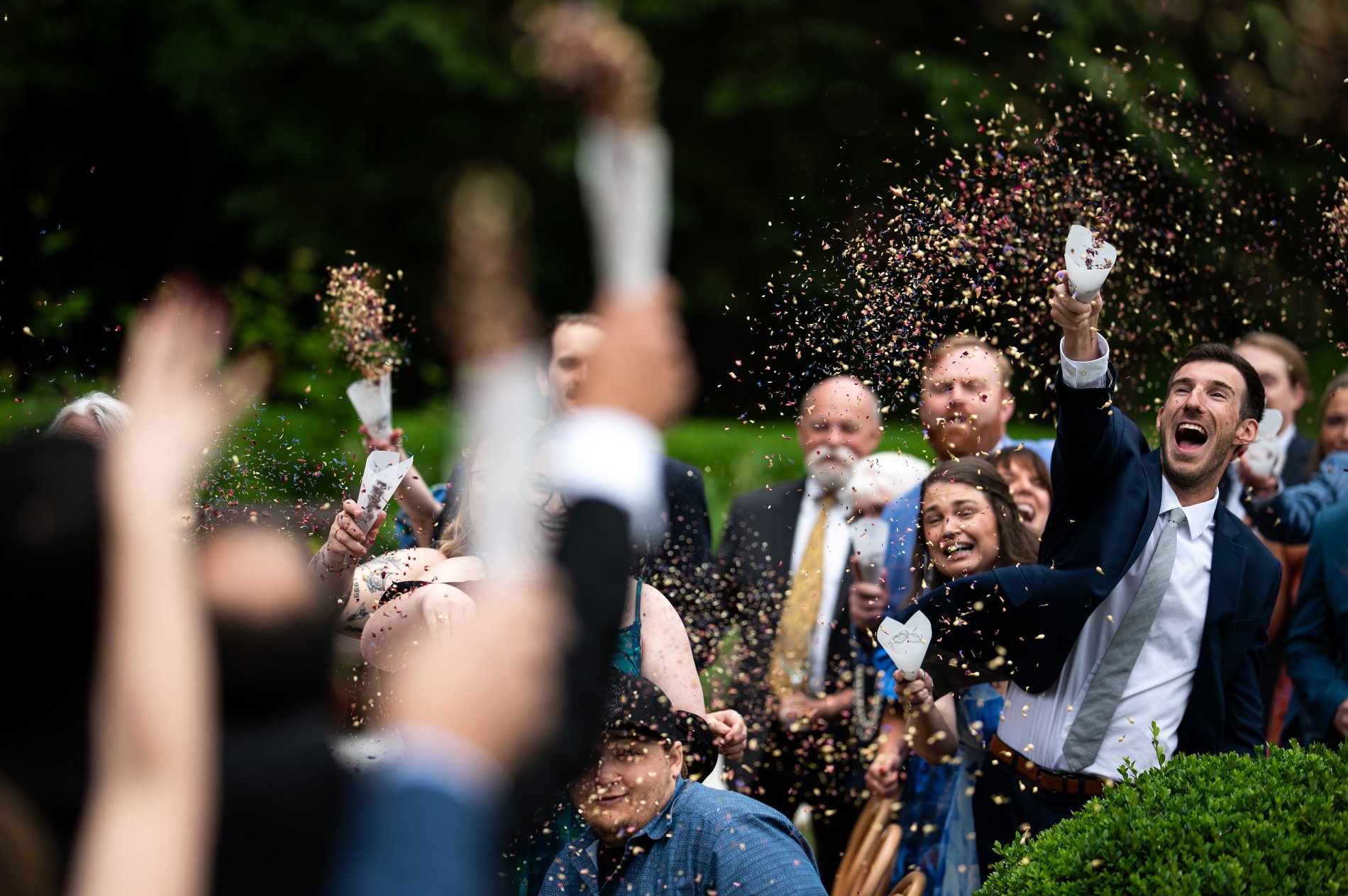 Guests throw confetti as the couple walks down the aisle together after their wedding ceremony at The Mount in Lenox, Massachusetts.