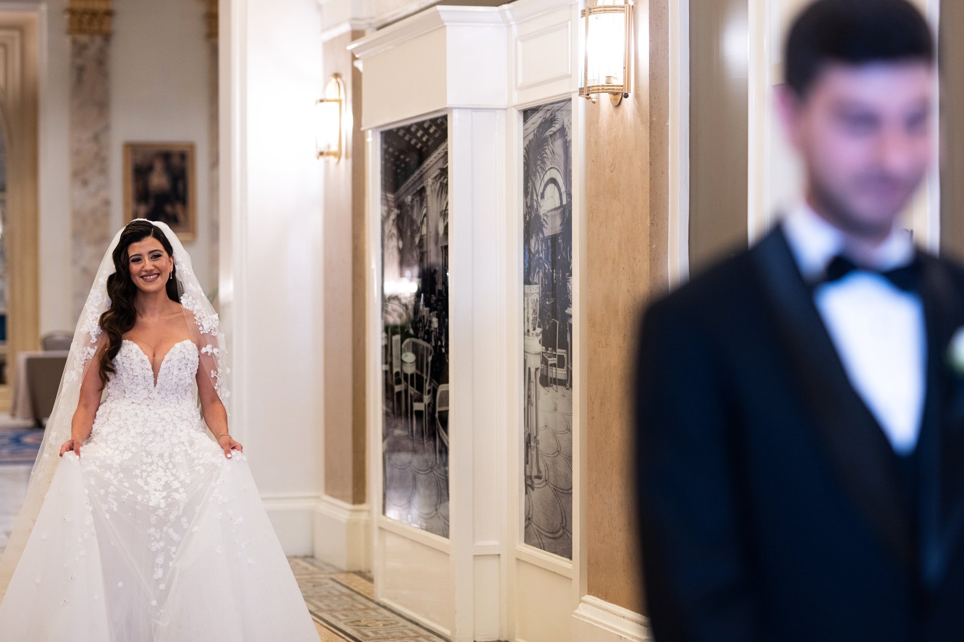 A bride walks to meet her husband to be during their first look at Fairmont Copley Plaza Hotel