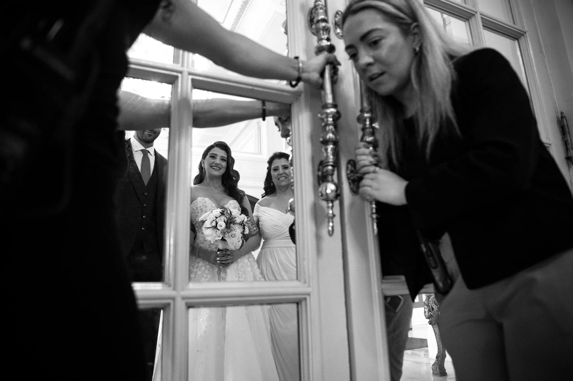 A bride stands with her mother and brother before walking down the aisle during her Boston wedding photojournalism session at Fairmont Copley Plaza in Boston.