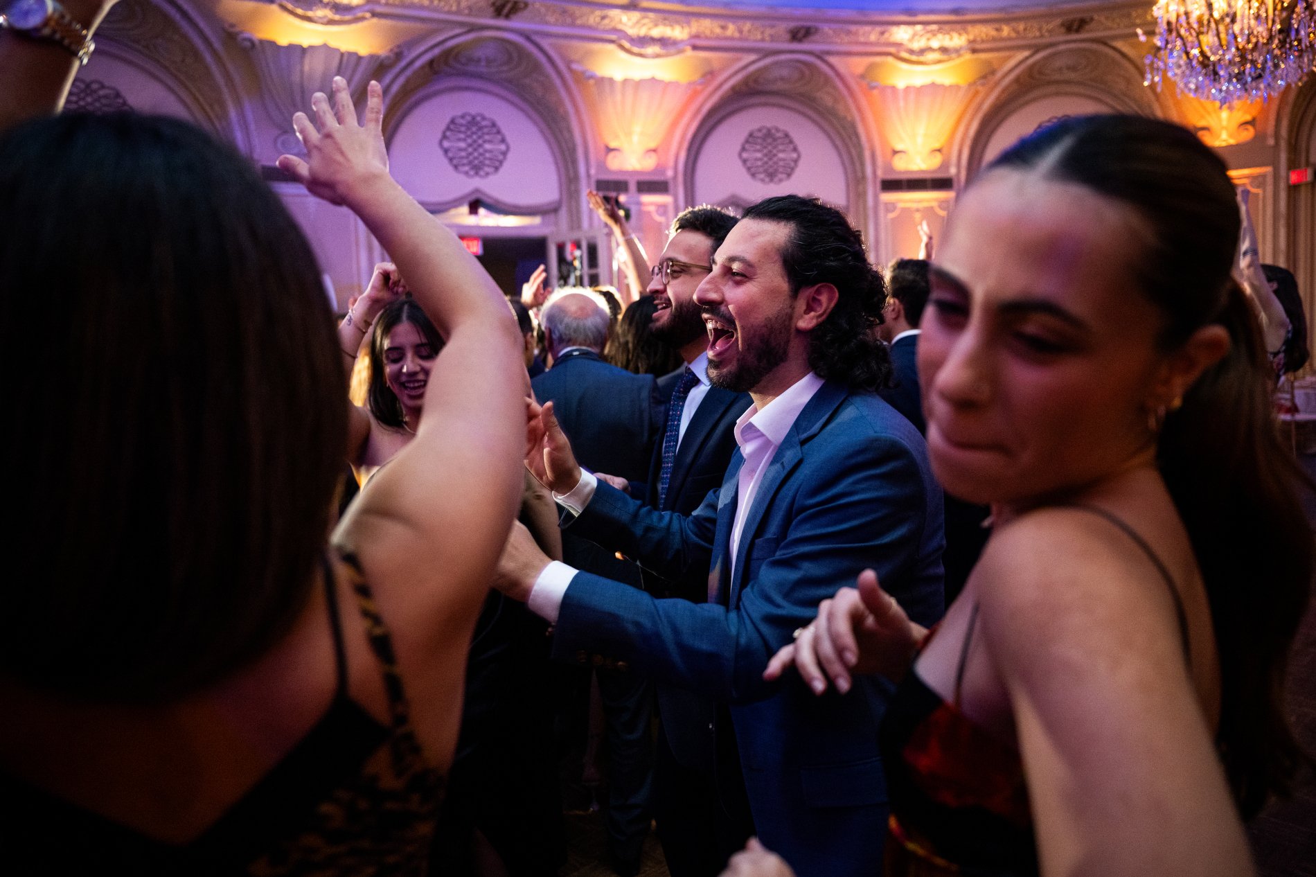 Guests dance during a Boston wedding photojournalism session at Fairmont Copley Plaza Hotel.