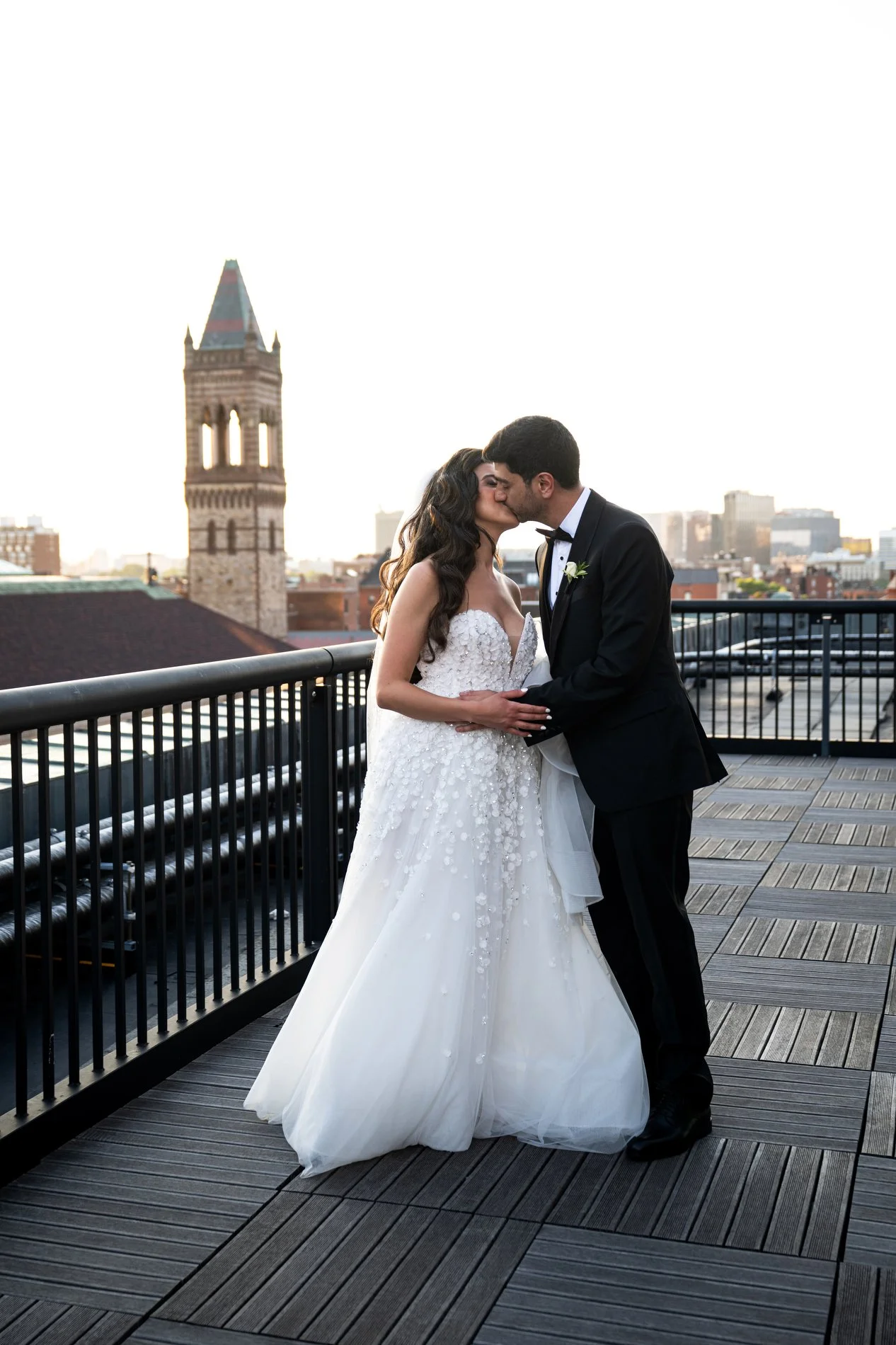 A bride and groom kiss on the roof of the Fairmont Copley Plaza Hotel in Boston during their documentary-style wedding photography session.
