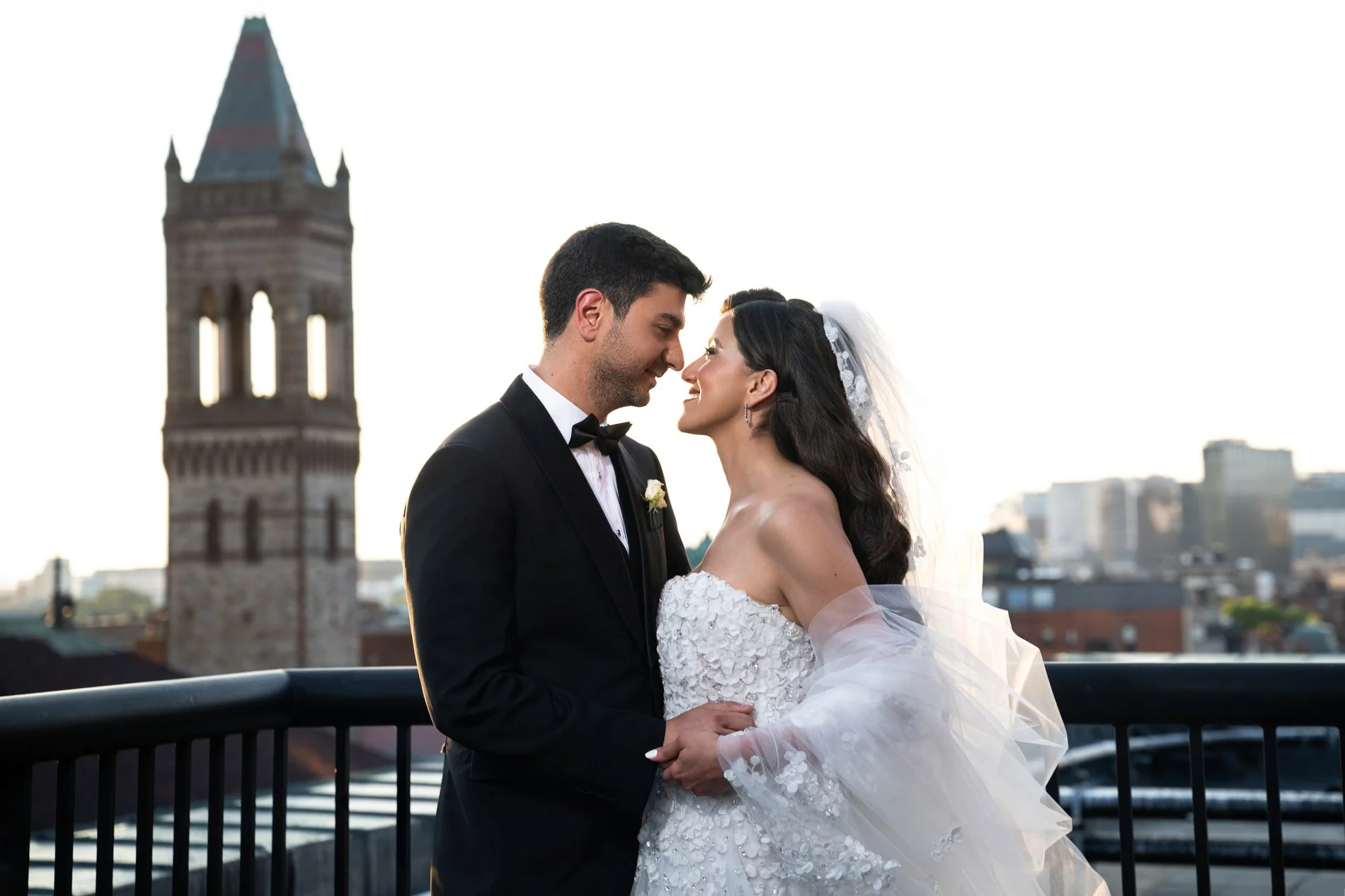 A bride and groom kiss on the roof of the Fairmont Copley Plaza Hotel in Boston during their documentary-style wedding photography session.