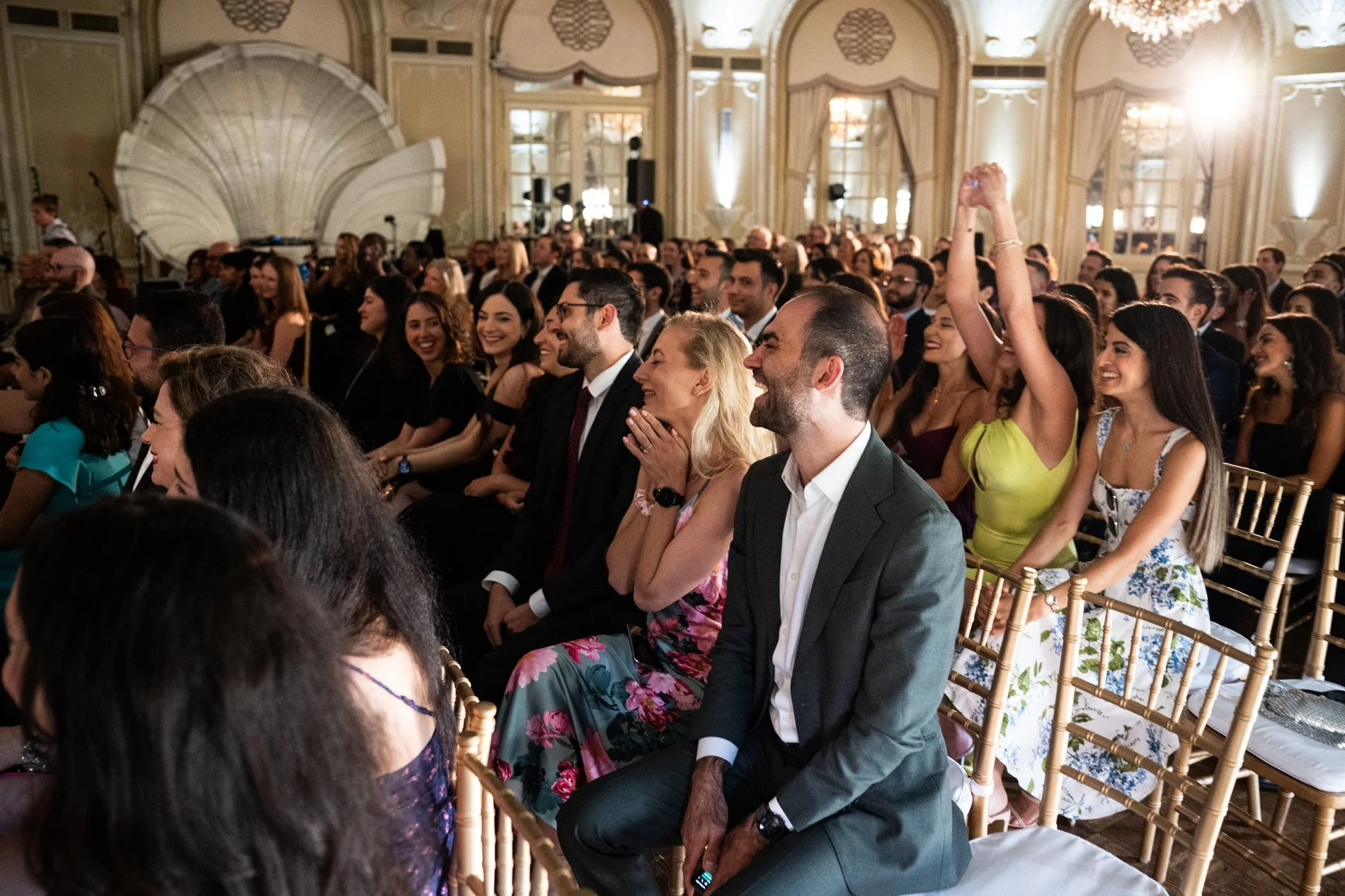 Guests cheer during a Boston wedding photojournalism session at Fairmont Copley Plaza Hotel.