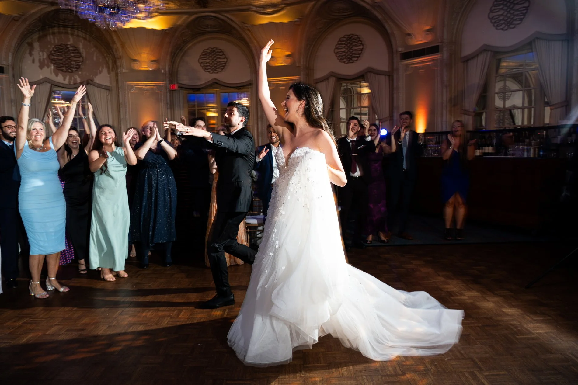 A bride and groom enter their wedding reception during their documentary wedding photography session at Fairmont Copley Plaza Hotel.