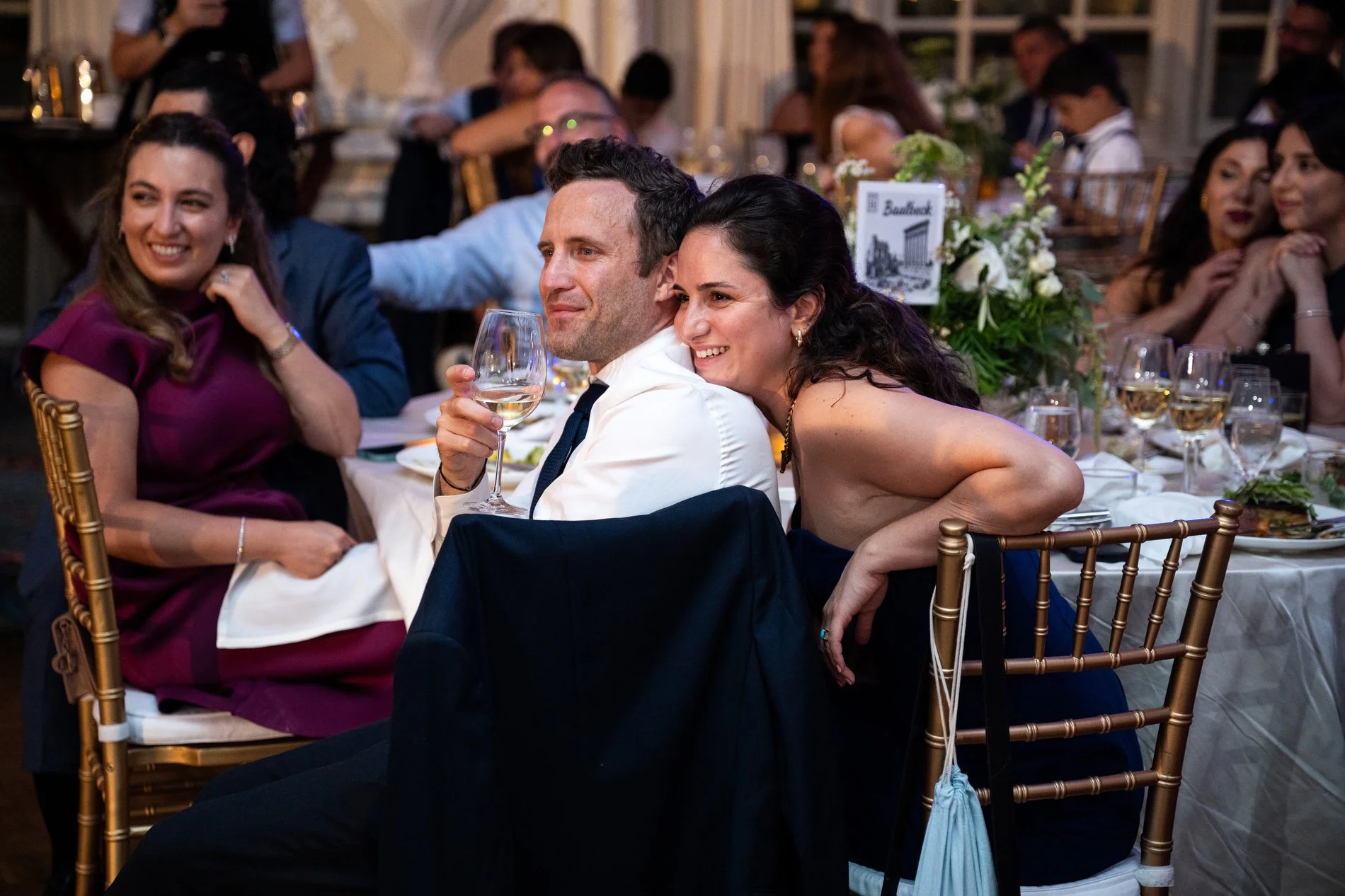 A couple listens to a toast during a Boston wedding photojournalism session at Fairmont Copley Plaza Hotel.