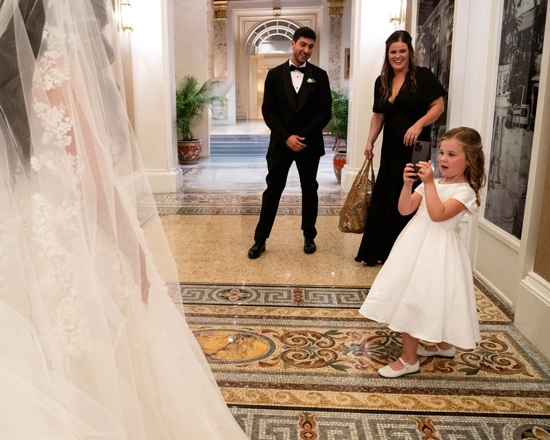 A young girl asks to take a photo of the bride at Fairmont Copley Plaza Hotel in Boston.