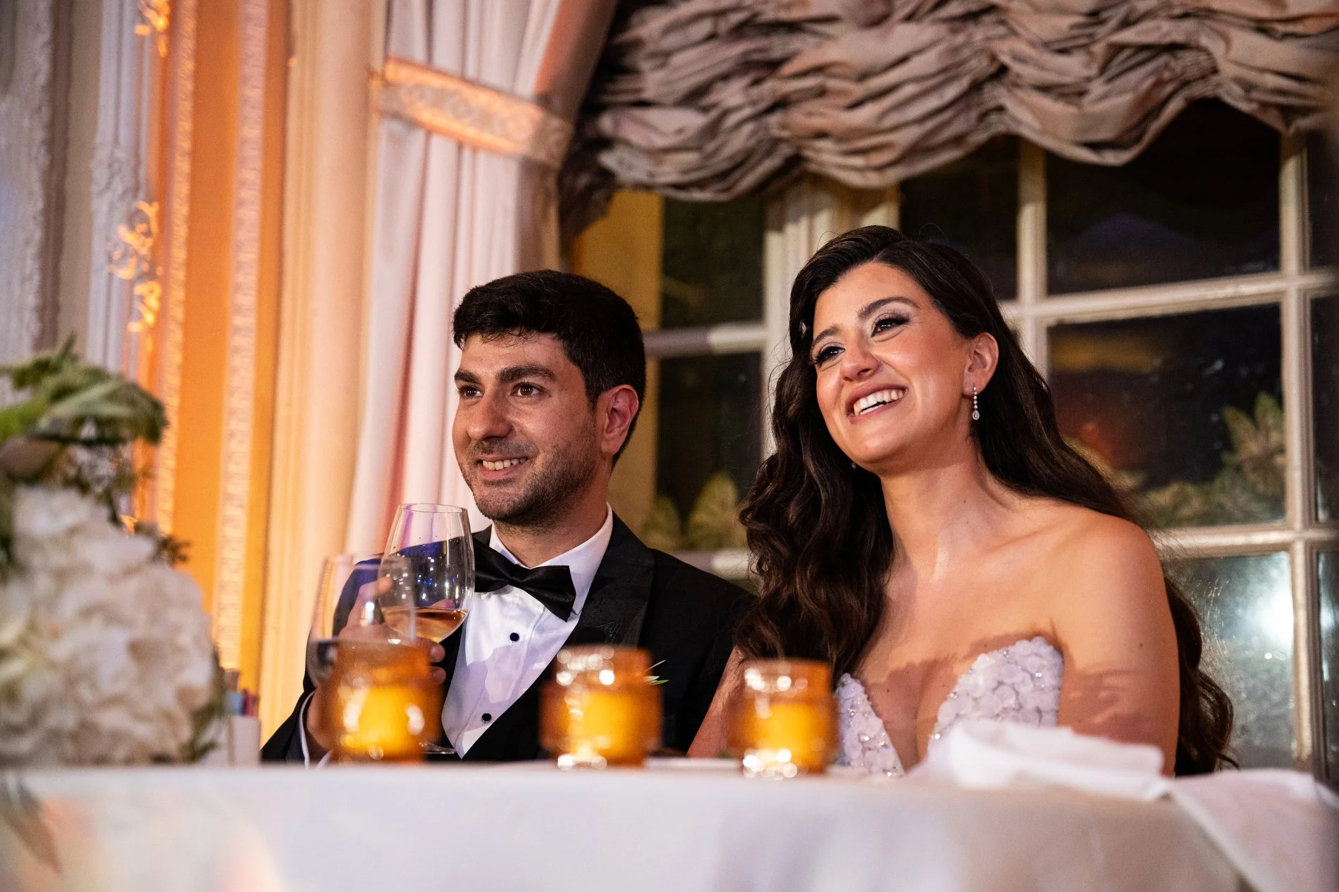 A couple listens to a toast during their Boston wedding photojournalism session at Fairmont Copley Plaza Hotel.
