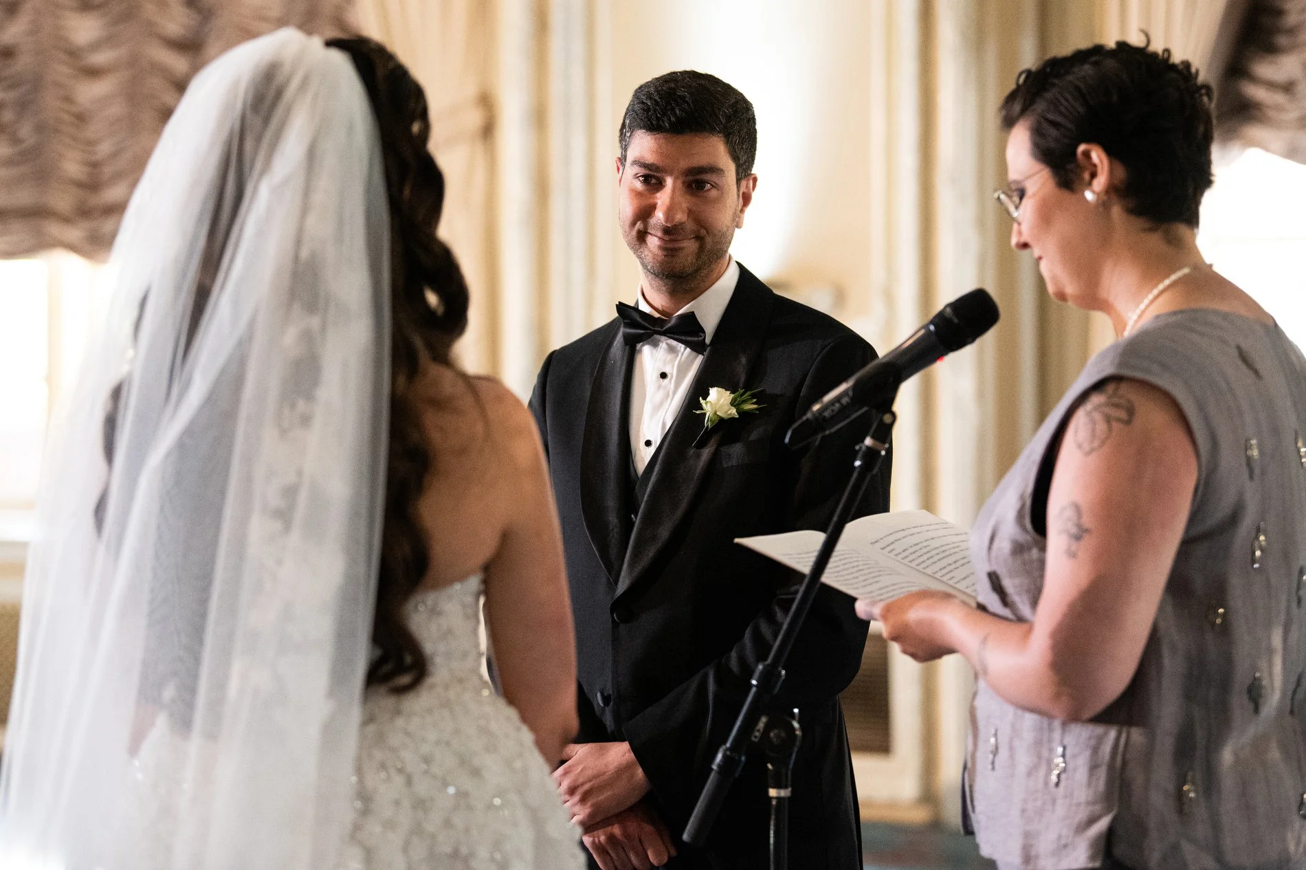 A groom smiles at his bride during their Boston documentary wedding session at Fairmont Copley Plaza Hotel.
