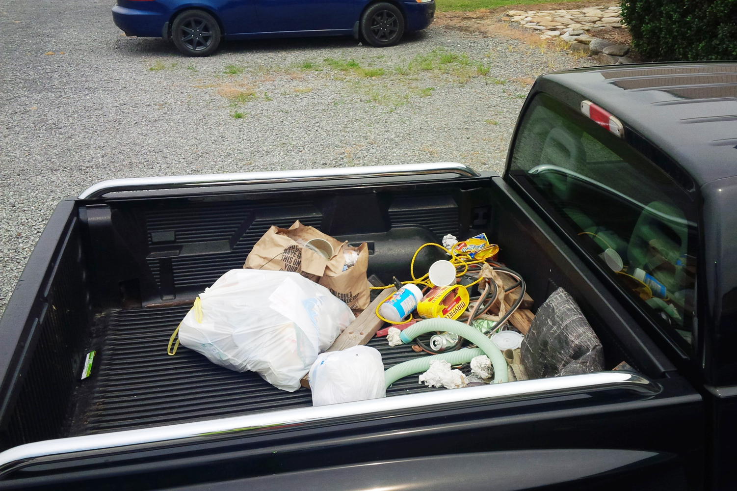 This pickup truck bed has loose trash that can easily fly out of the back of the vehicle and litter the road. Help keep our local roads clean by securing loads and putting trash in the right place.