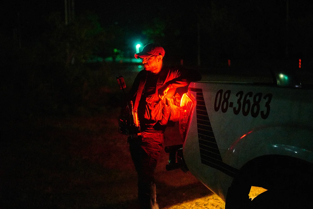  A video journalist for a national news broadcaster awaits information at a murder scene.  