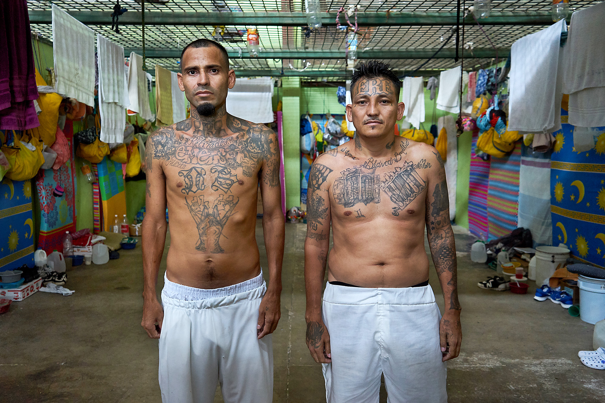 Ex MS-13 pandilleros (gang members) Nelson and Franklin, serving time for homicide and extortion respectively, stand in their cell in Apanteos prison, Santa Ana. The cell houses approximately 30 inmates. Both men are enrolled in the 'Yo Cambio' (I