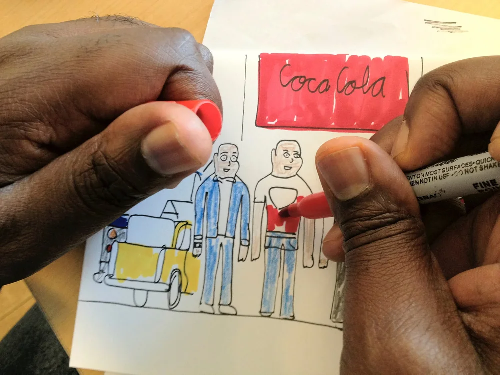 An artist drawing at LAND Studio and Gallery