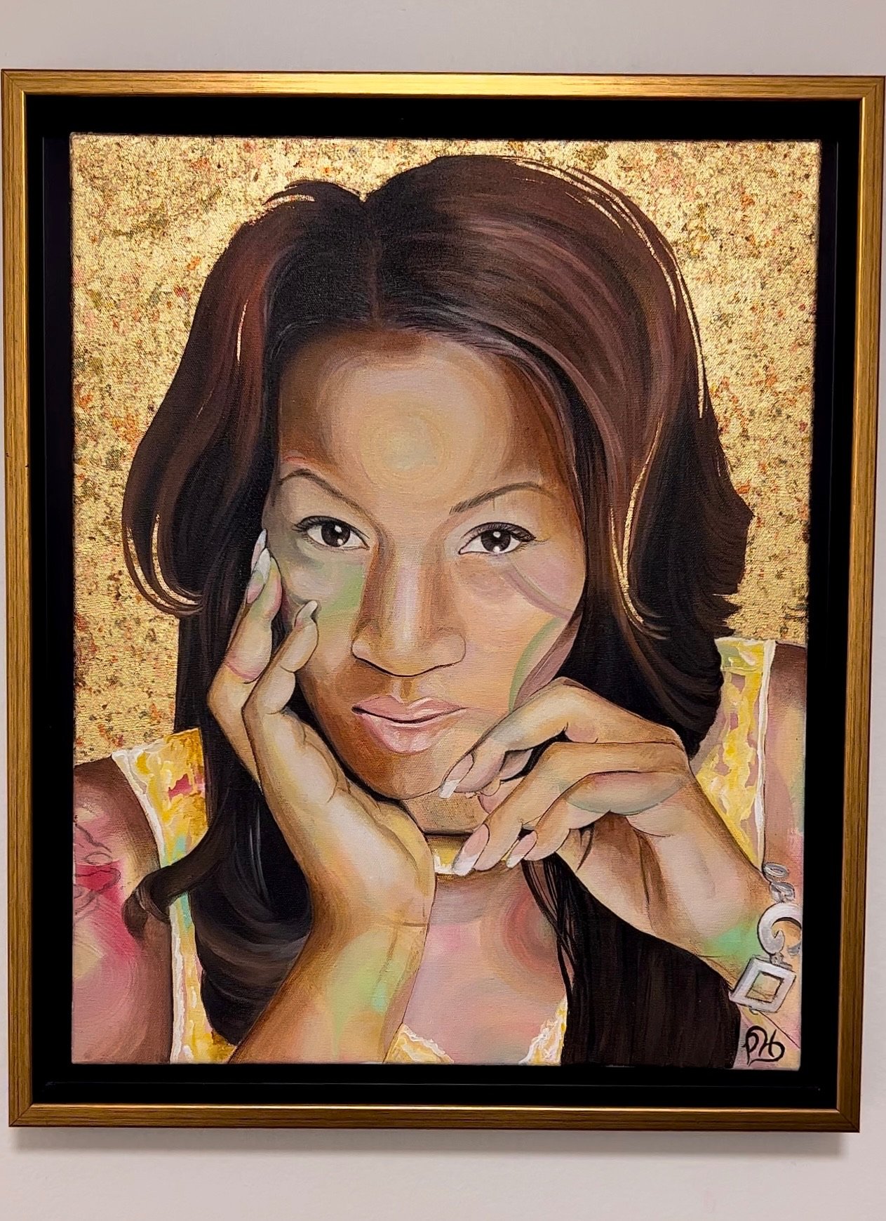 Portrait painting of a woman with long hair framed in a gold border. Her hands touch her face and she looks thoughtfully at the viewer.