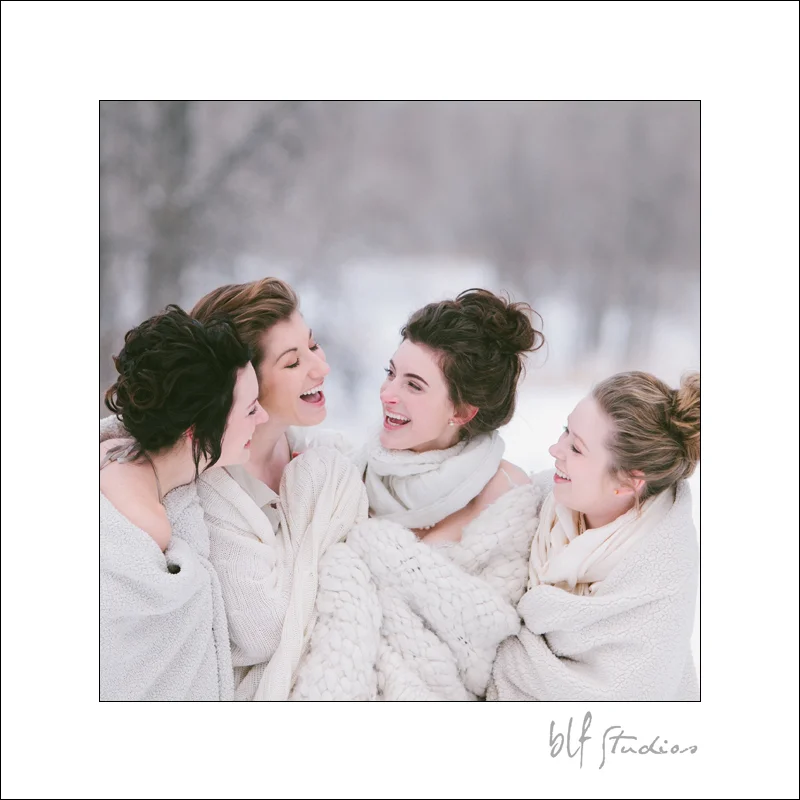 bride and bridesmaids having fun in the snow.jpg