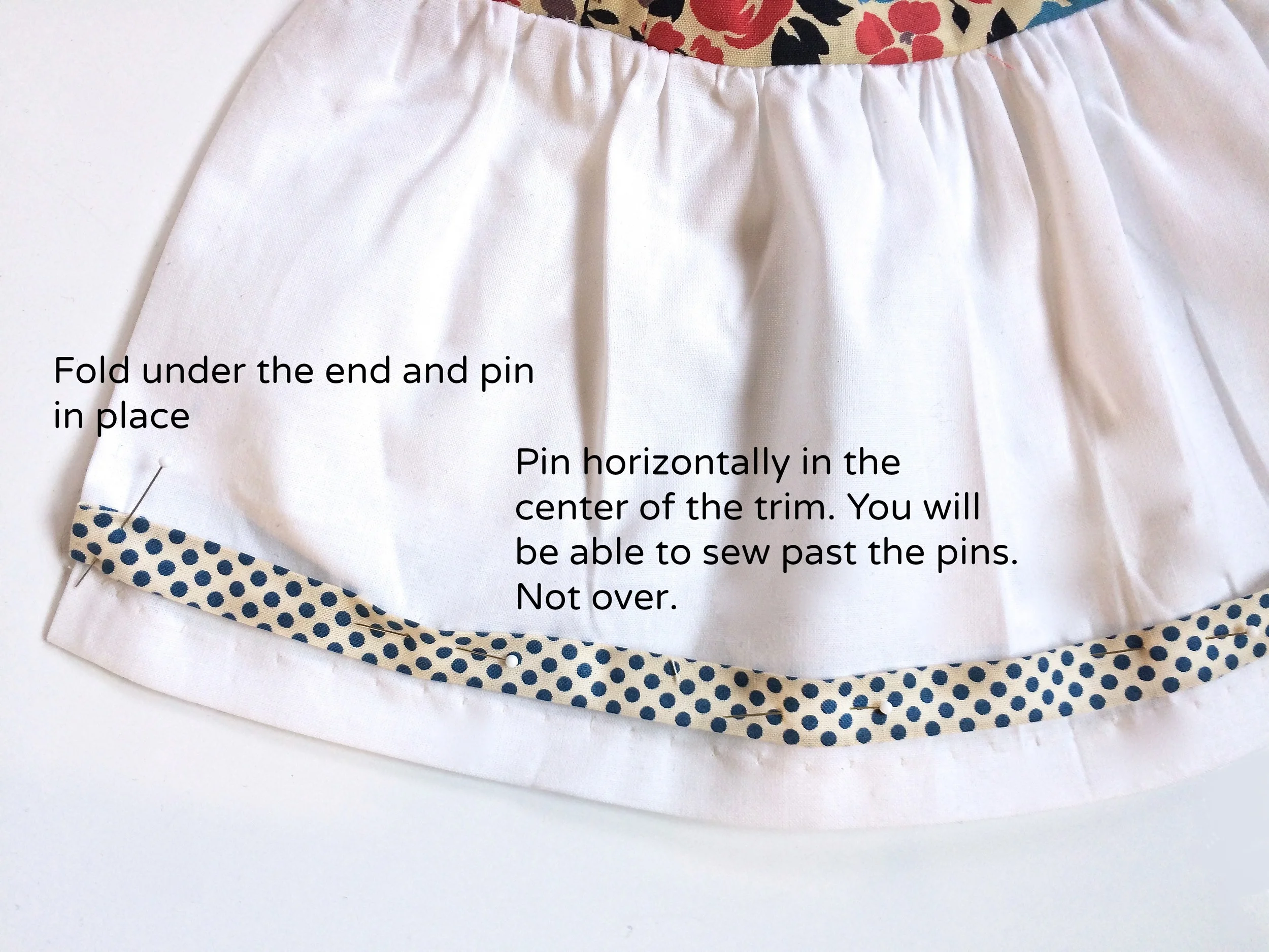 Pinning your trim so you can sew.