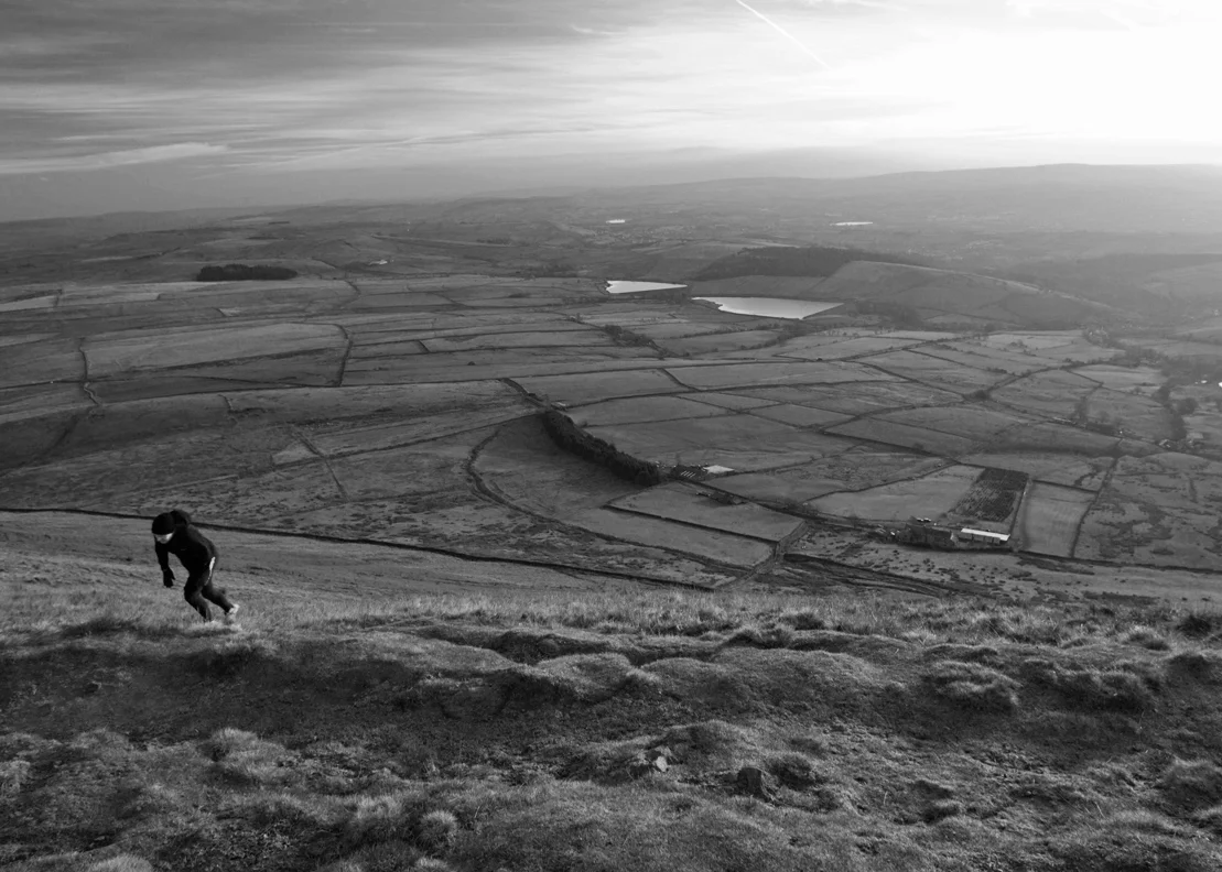 A fell runner reaches Pendle summit the hard way, straight up the Pendleside slope.