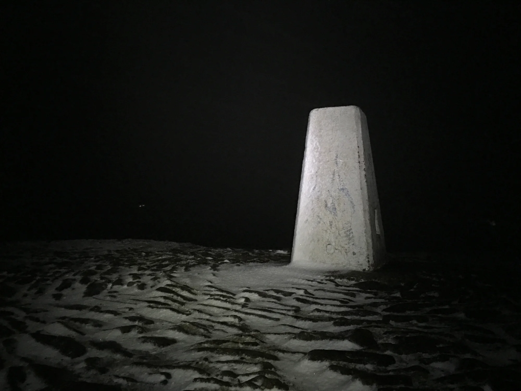 Darkness at Pendle trig point.