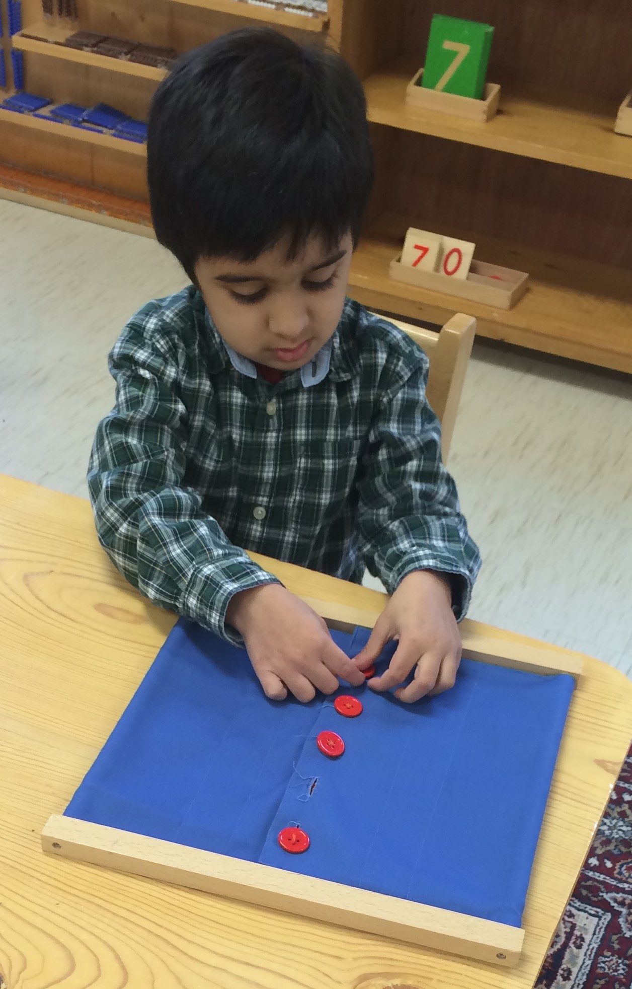 The button frame along with the zipper, snap, velcro, lacing, bow, and hook and eye frames give the child the necessary skills to dress themselves no matter what type of fastener their clothes may contain.