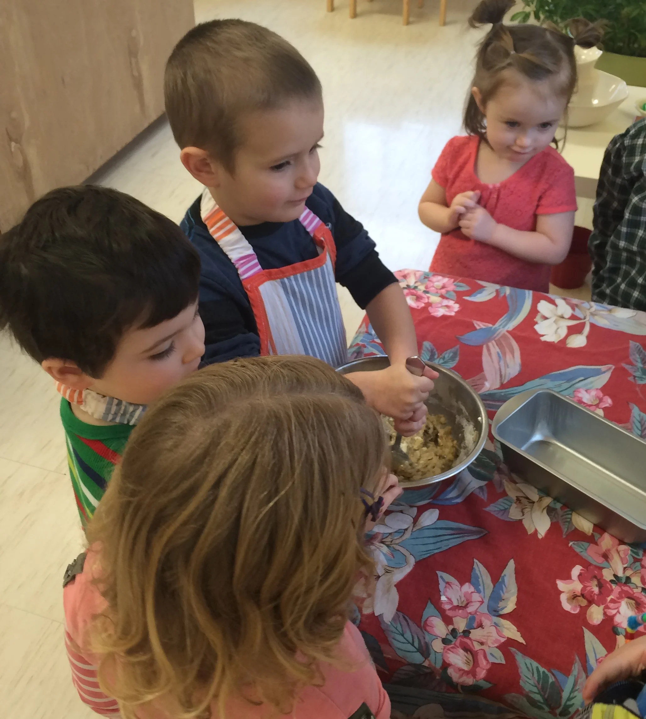 Baking in the Montessori environment utilizes math, reading, and science skills. Who doesn't love to demonstrate their culinary skills to others. The specialty of the day is banana bread.