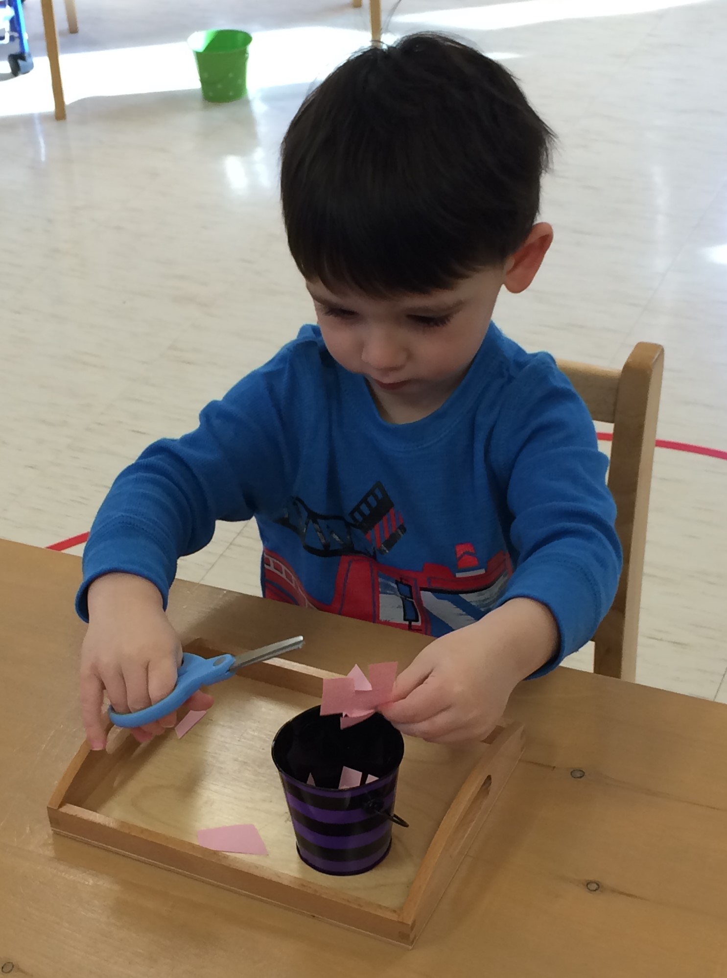 The scissor material guides the child in cutting blank strips of paper and gradually increases in difficulty with lined, wavy, zig zag, and other strips of paper. 