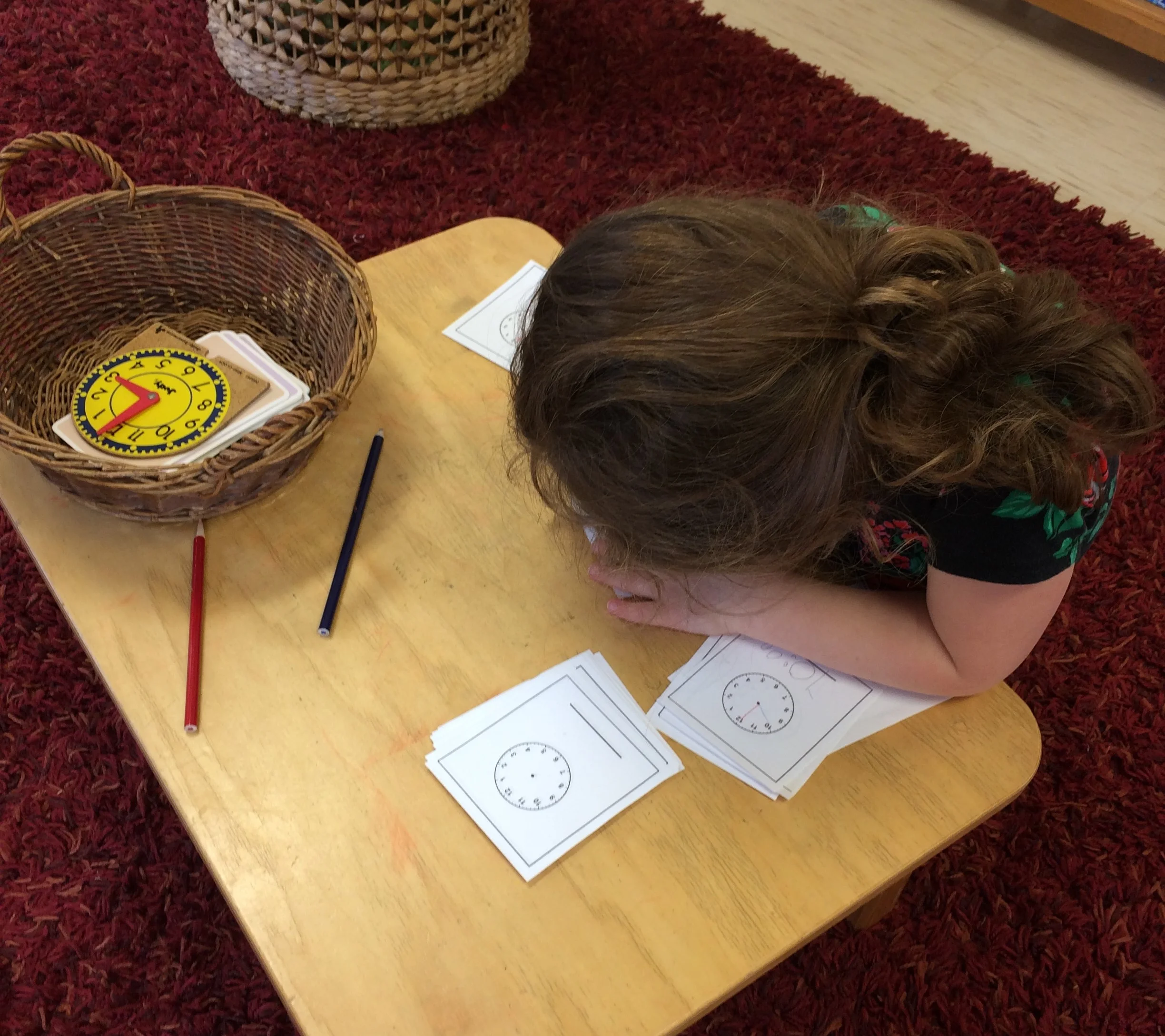 The clock material teaches the child how to tell time.