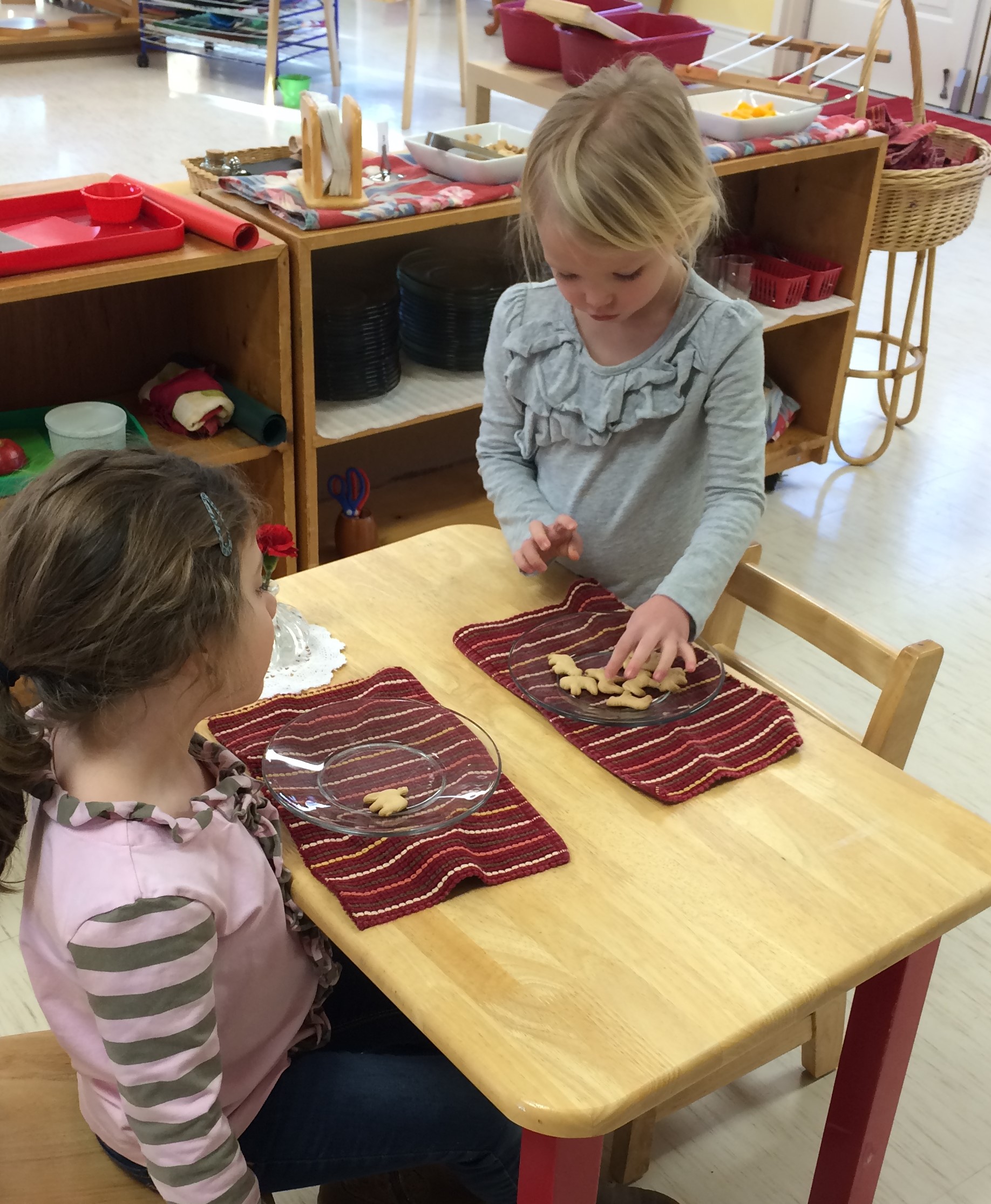 We cannot forget snack as it is an intricate part of the day. The children eat in pairs. Numbers are placed beside the snack allowing the children to help themselves to the allotted amount. The child is able to practice table manners and enjoy the company of their friend.