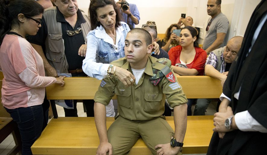 Israeli solider, Sgt. Elor Azaria, sits inside an Israeli military court in Tel Aviv, Israel, Monday, April 18, 2016. An Israeli military court charged Azaria with manslaughter for the fatal shooting of a wounded Palestinian attacker in the West Ban…