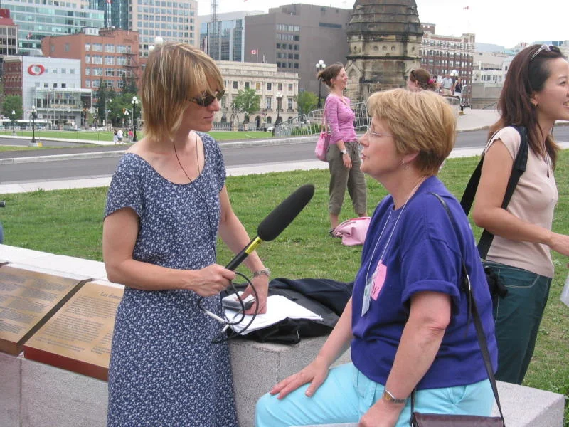 WOW Coordinator Marie Bouclin being interviewed by the press on Parliament Hill in Ottawa, Canada at the opening of WOW's Second International Conference.