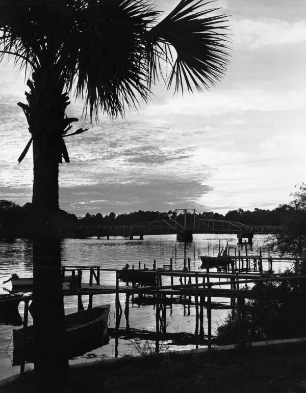 View looking past docks toward swing bridge on the Steinhatchee River